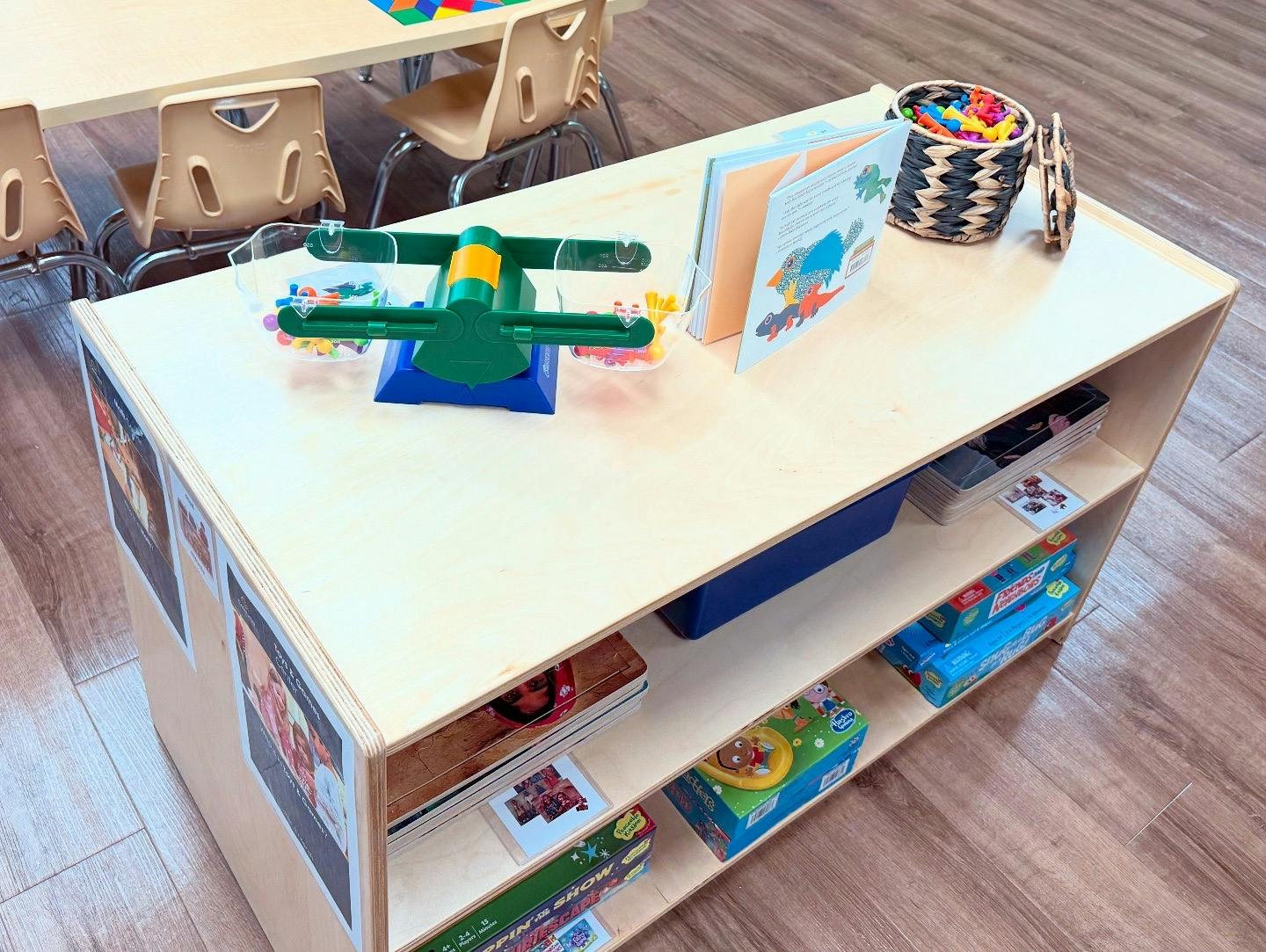 Toy airplane, books, and basket on a wooden shelf