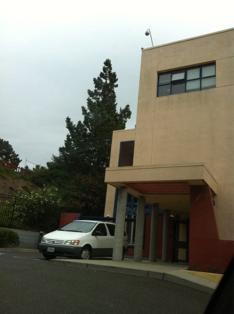 White van parked under a building overhang