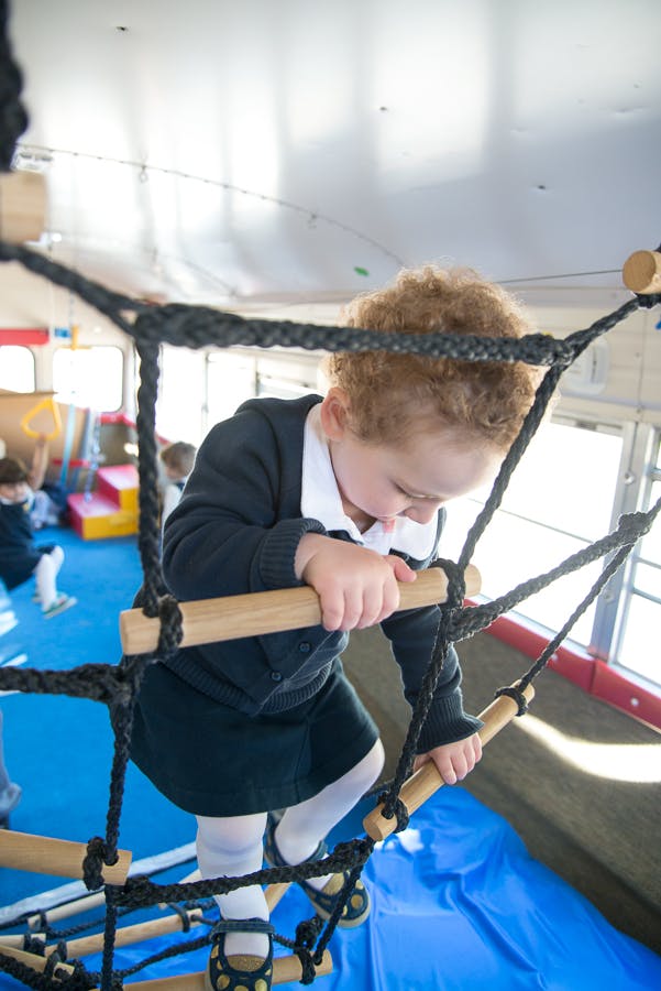 Child climbing on a rope ladder