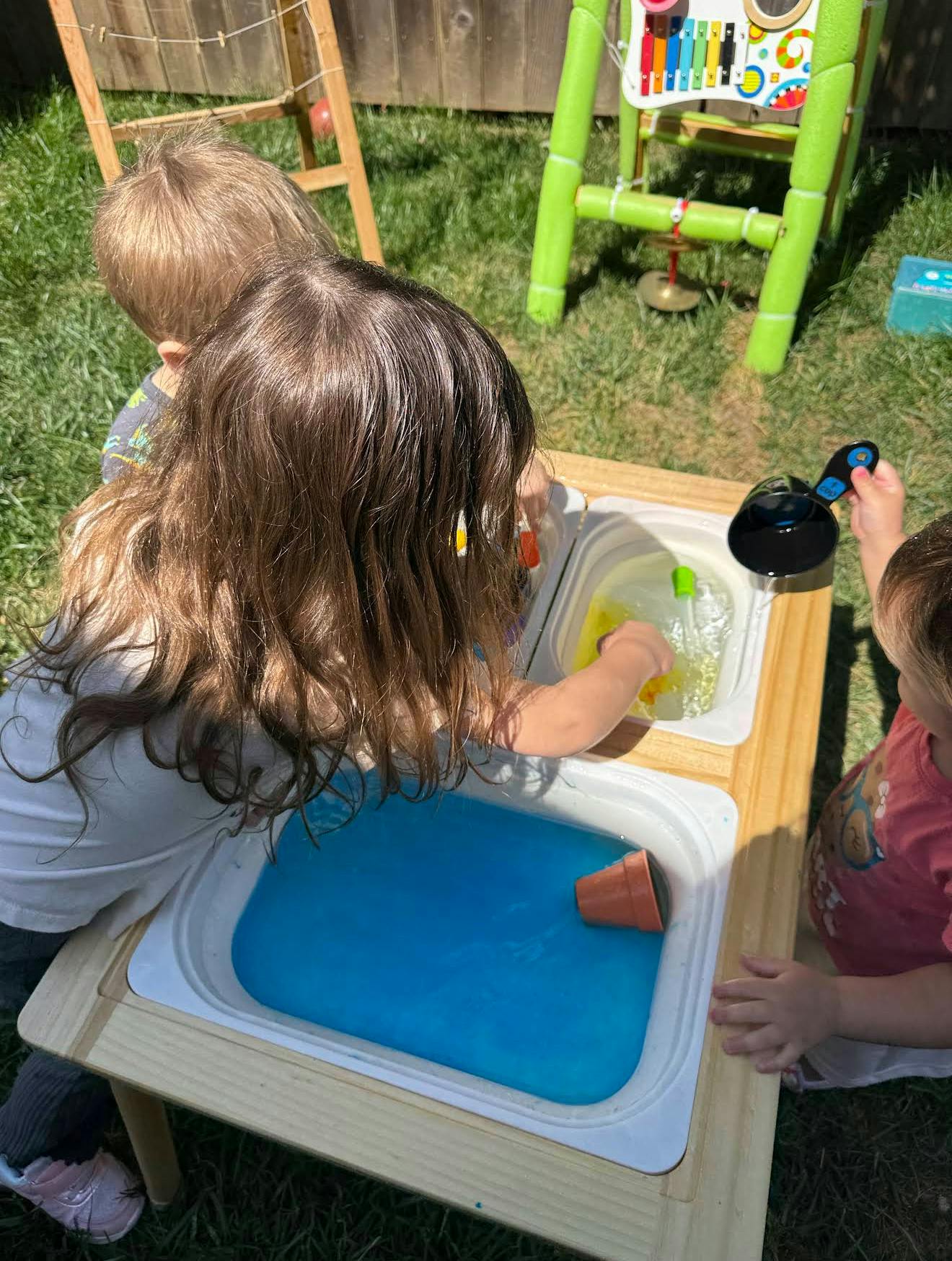 Children playing at a water table outdoors