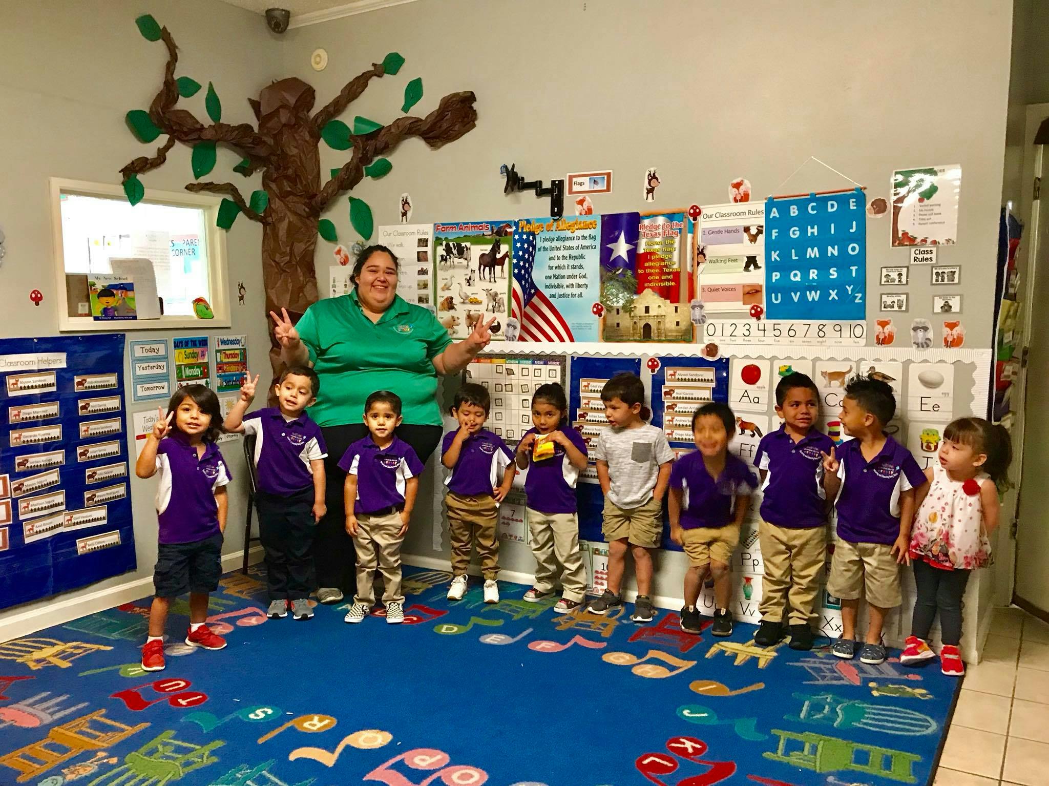 Adult and children posing in a classroom