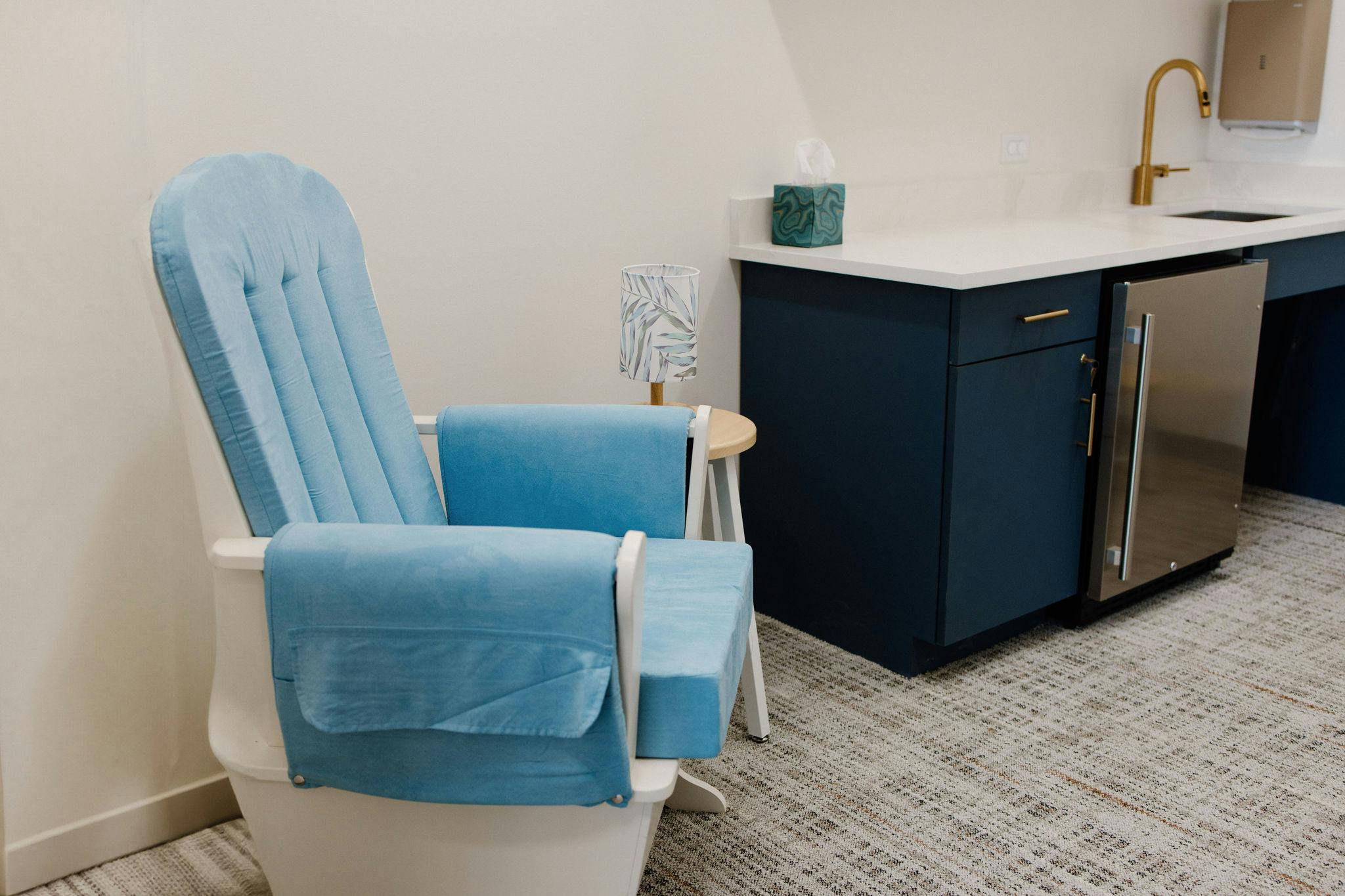 Armchair with a side table and sink in a modern room