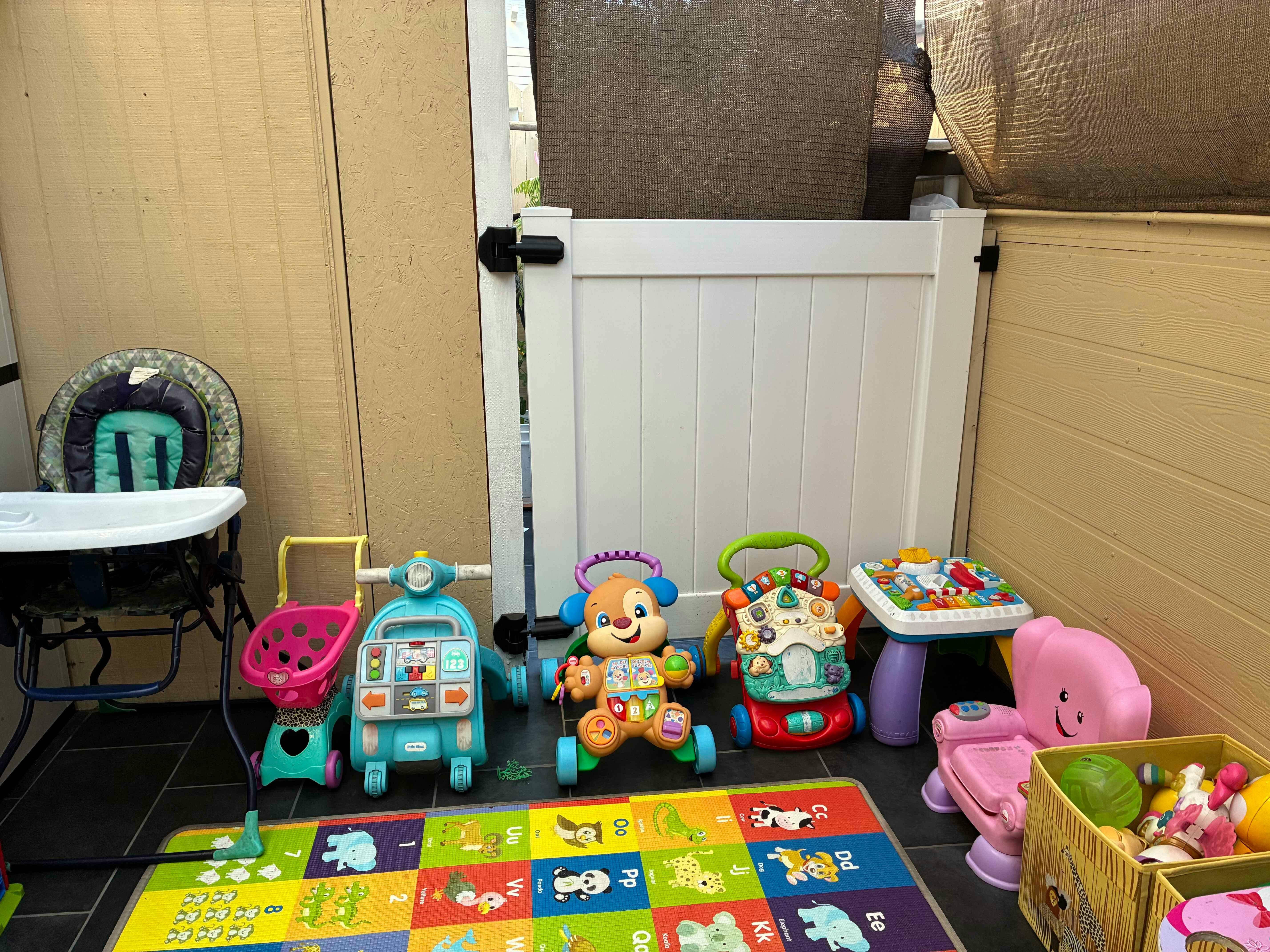 Baby toys and high chair on a playmat