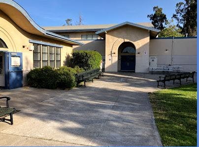 Exterior of a building with a curved roof and arched entrance