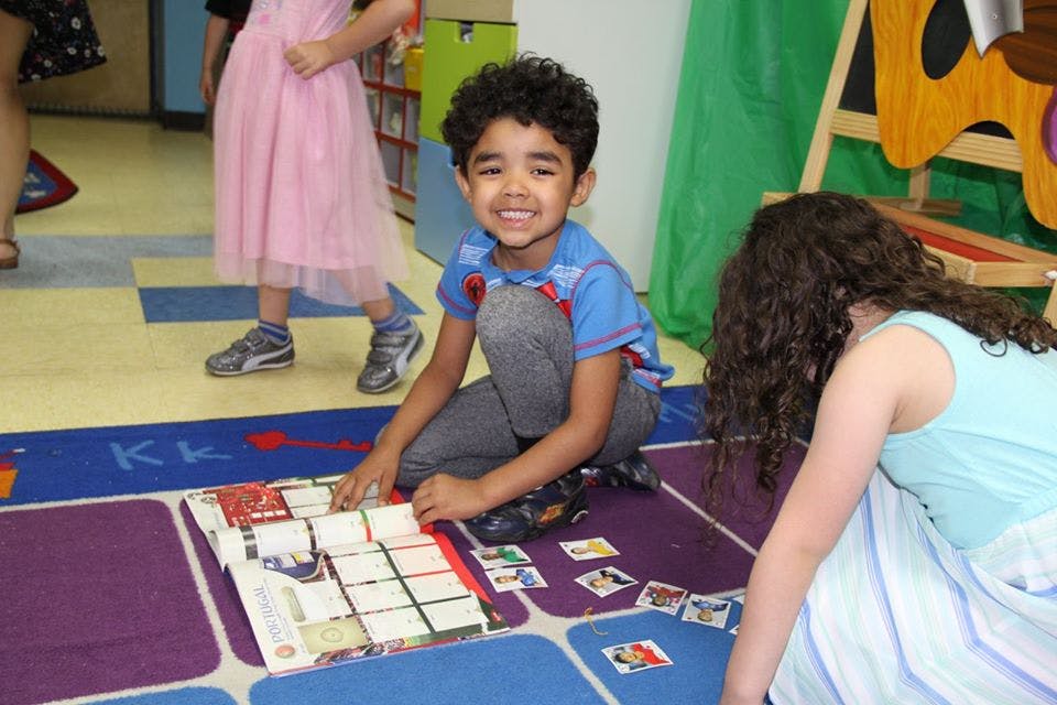 Child playing a board game on the floor
