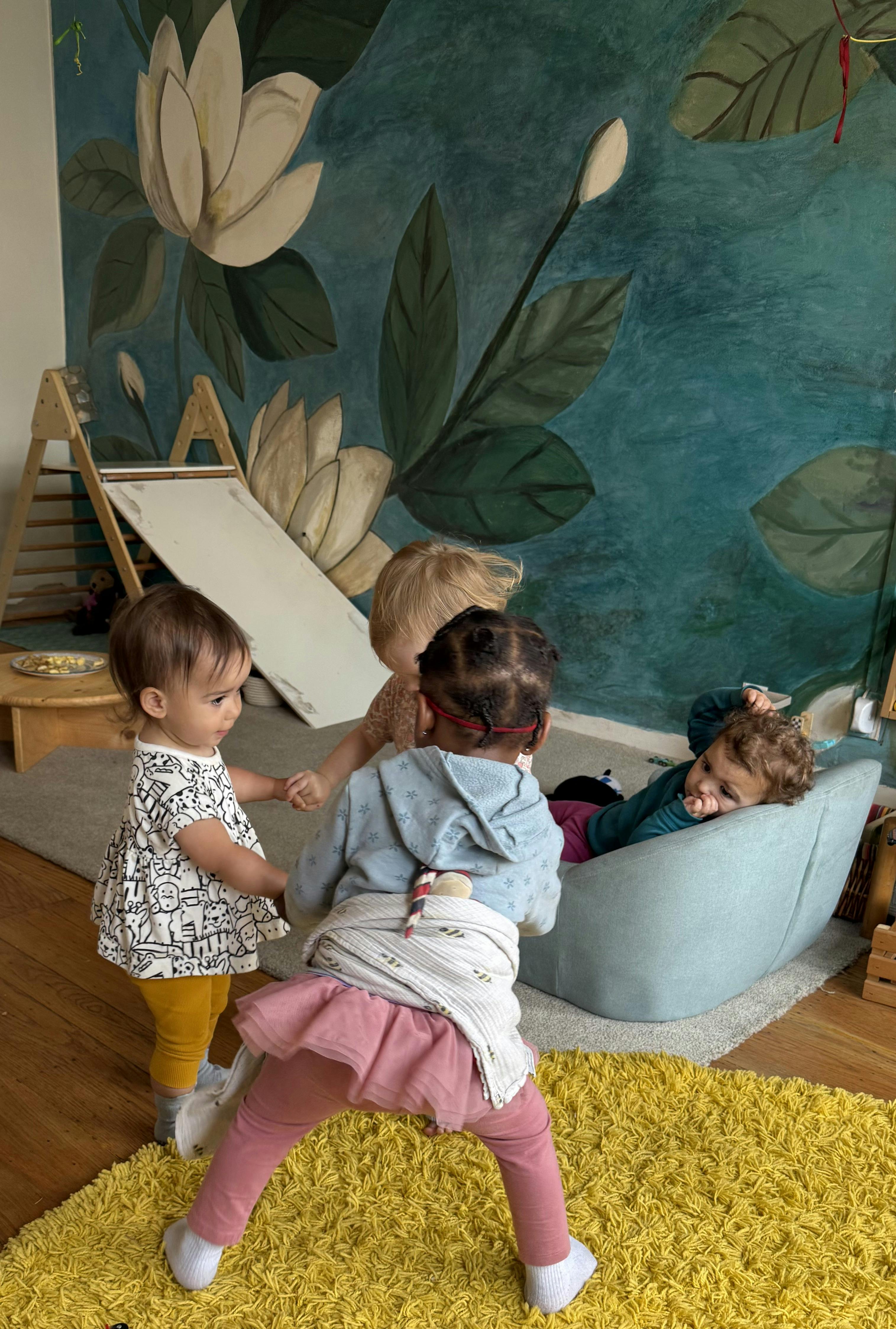 Children playing in a room with one child lying on a beanbag