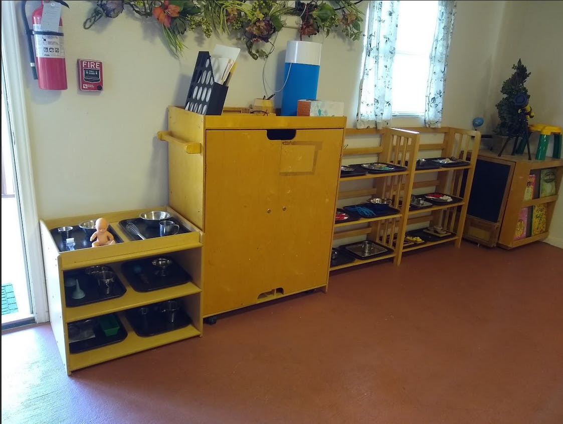 Classroom with yellow storage units and wooden shelves