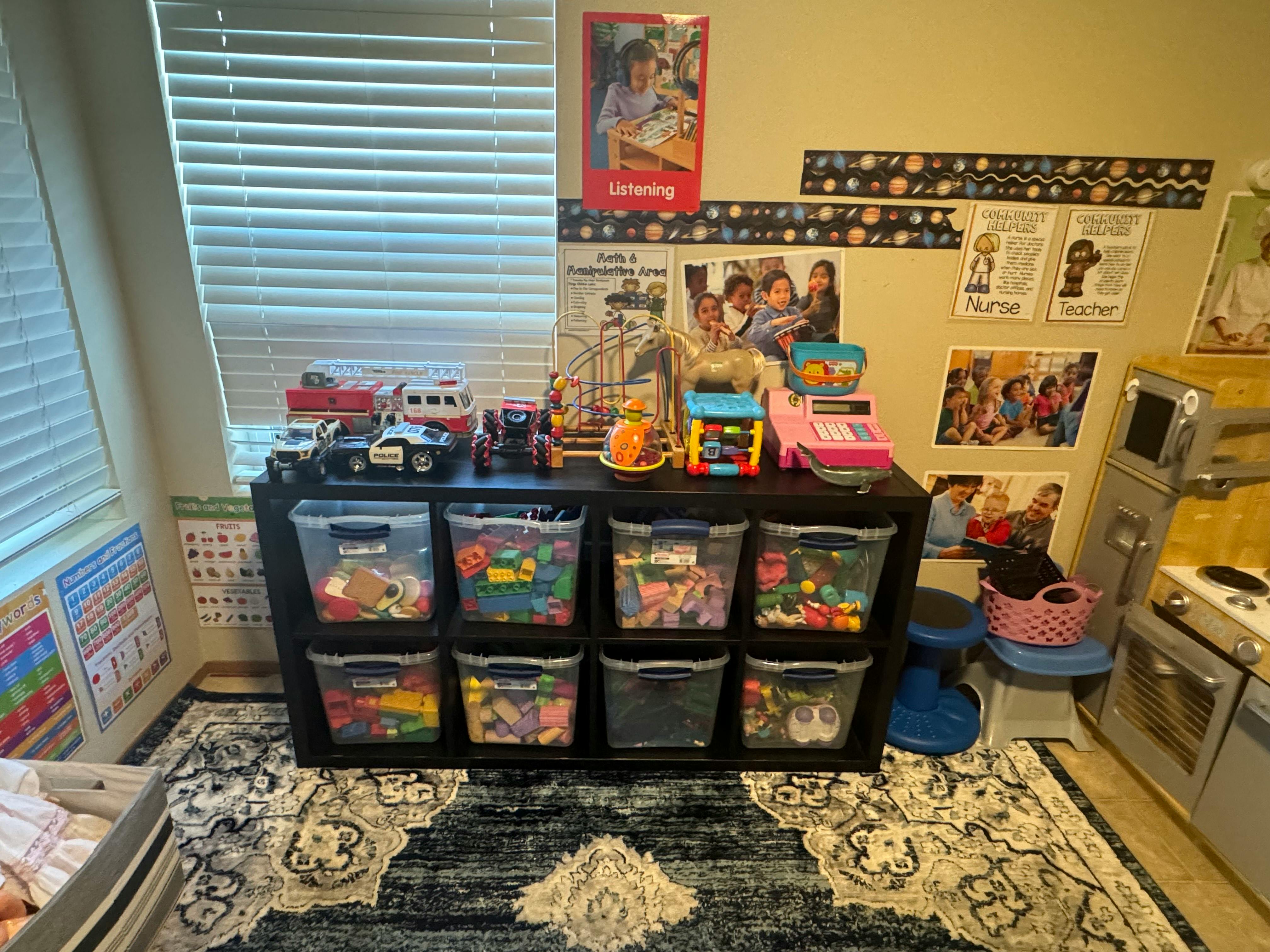 Toy storage unit with clear bins filled with toys