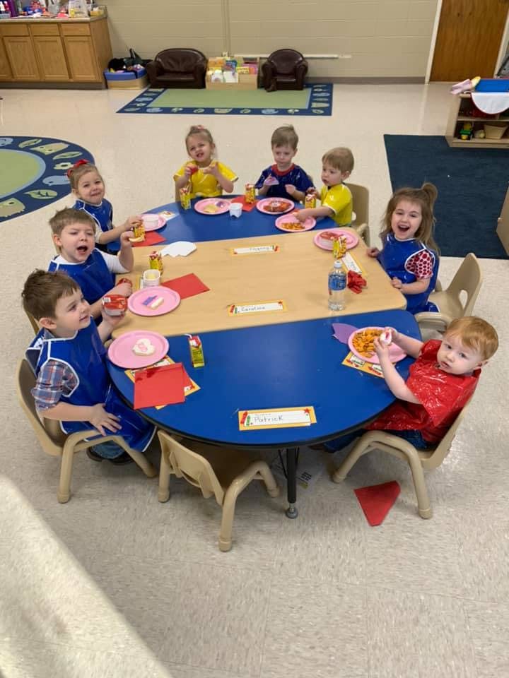 Children sitting around a table in a classroom