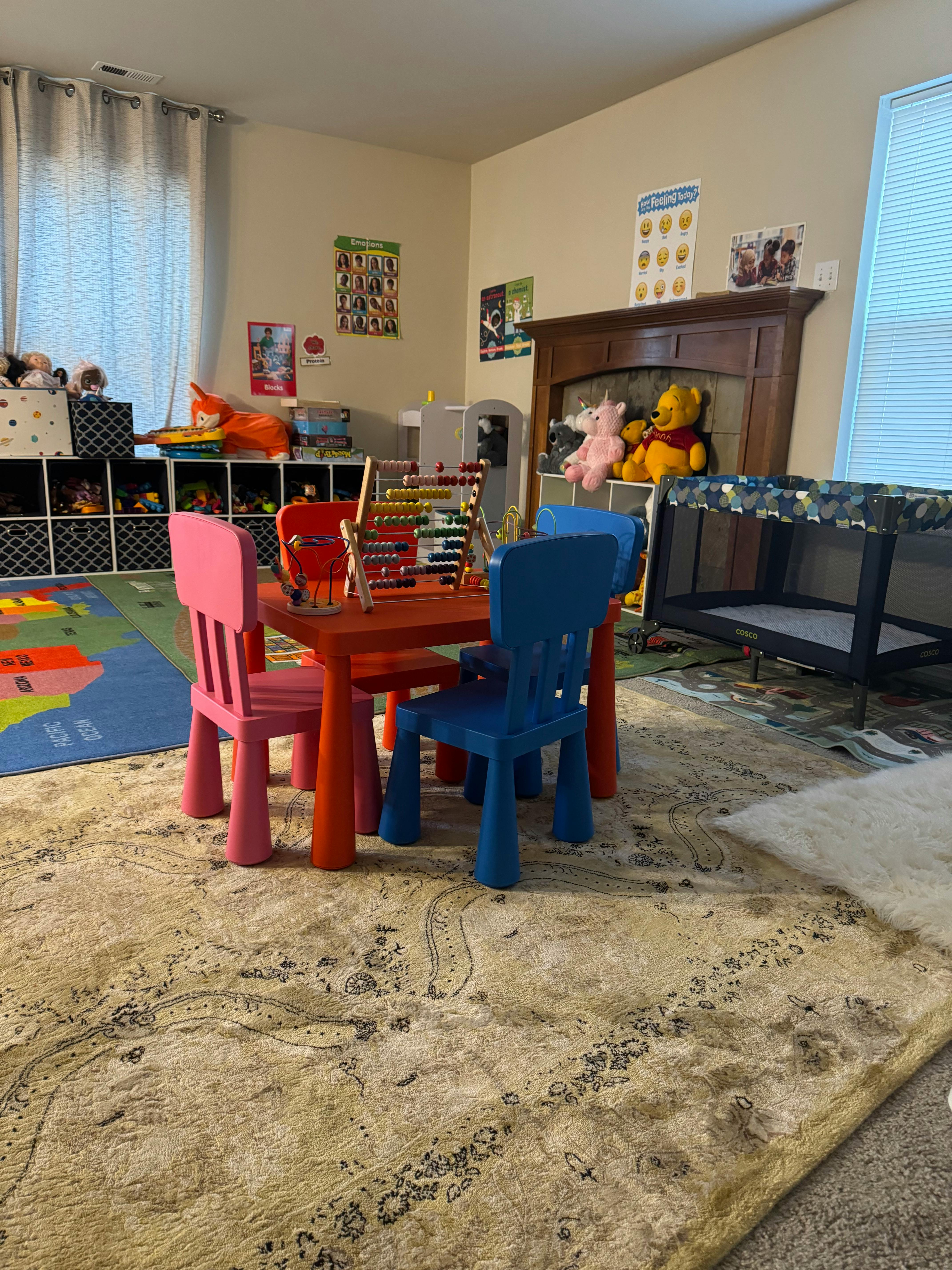 Children's play area with small table and chairs, abacus, and toys