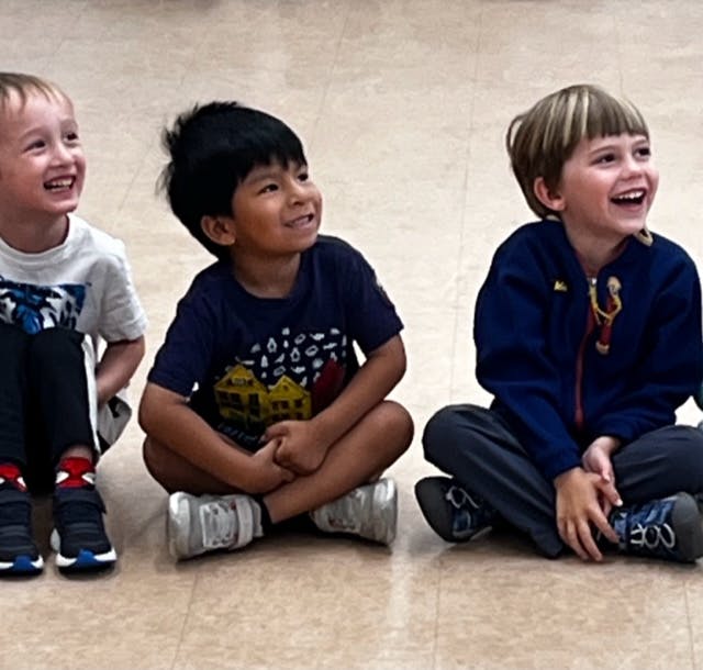 Three children sitting on the floor