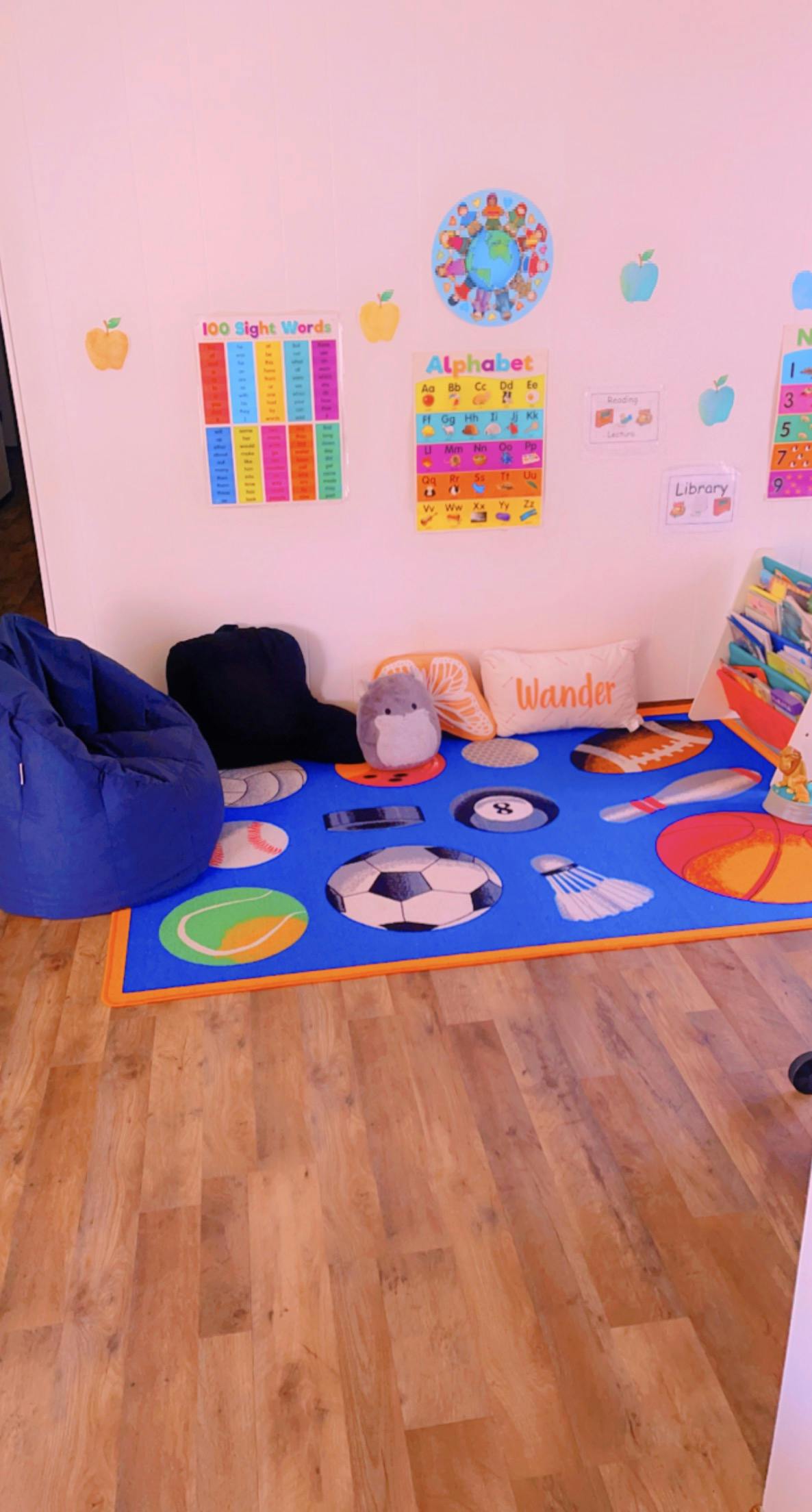 Playroom with a blue beanbag chair and a sports-themed rug