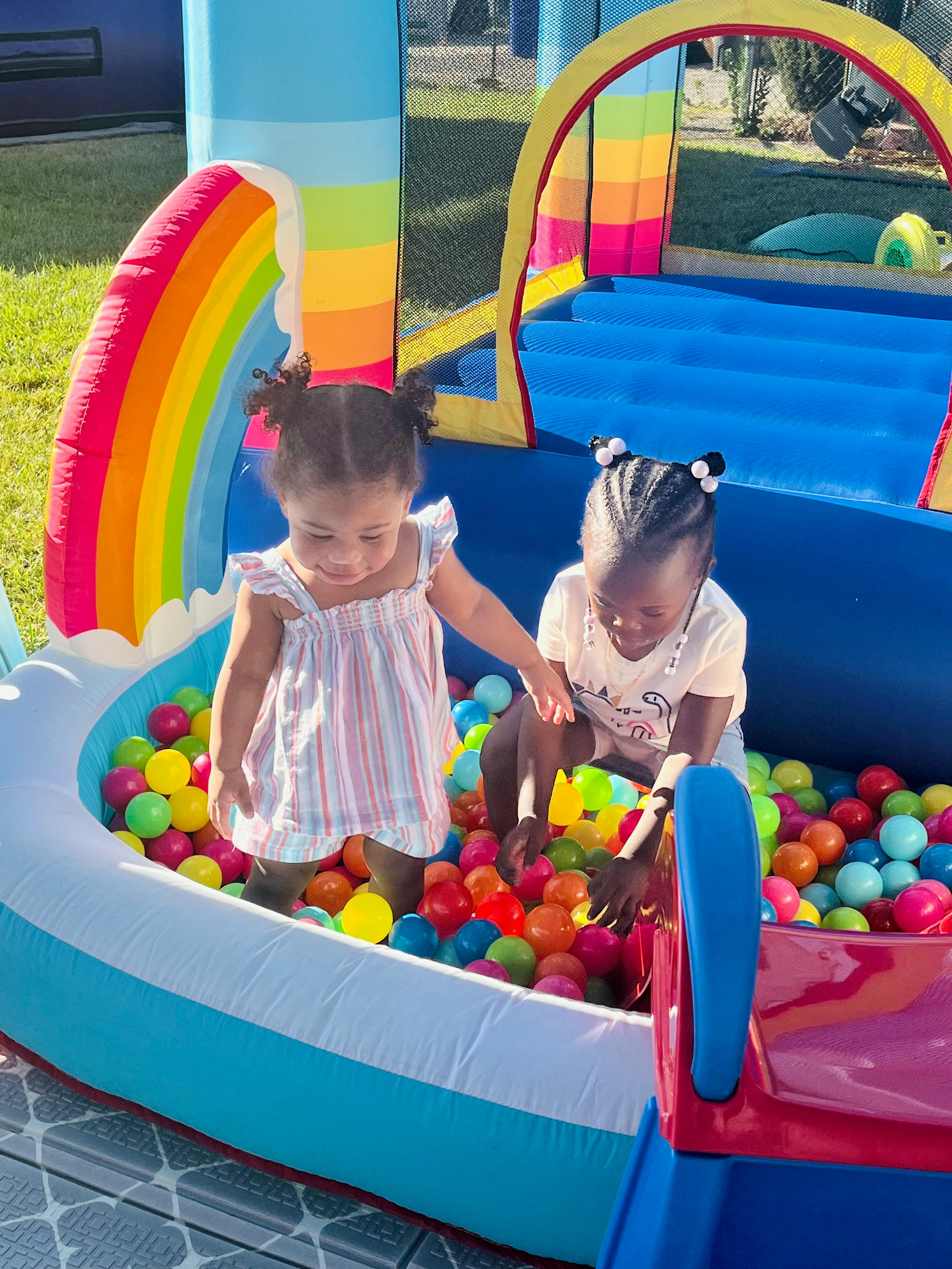 Two children playing in a ball pit