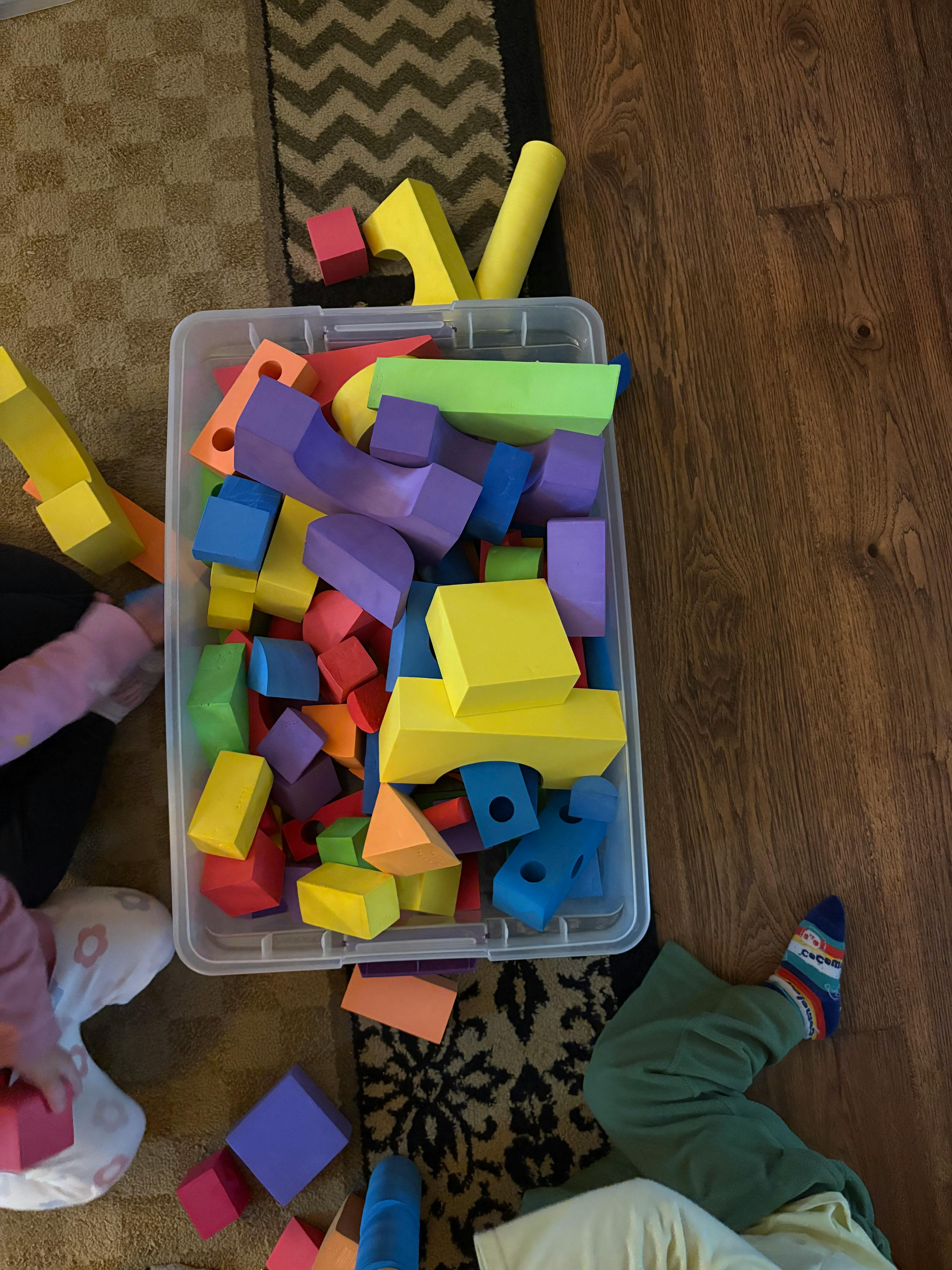 Plastic bin filled with colorful foam building blocks