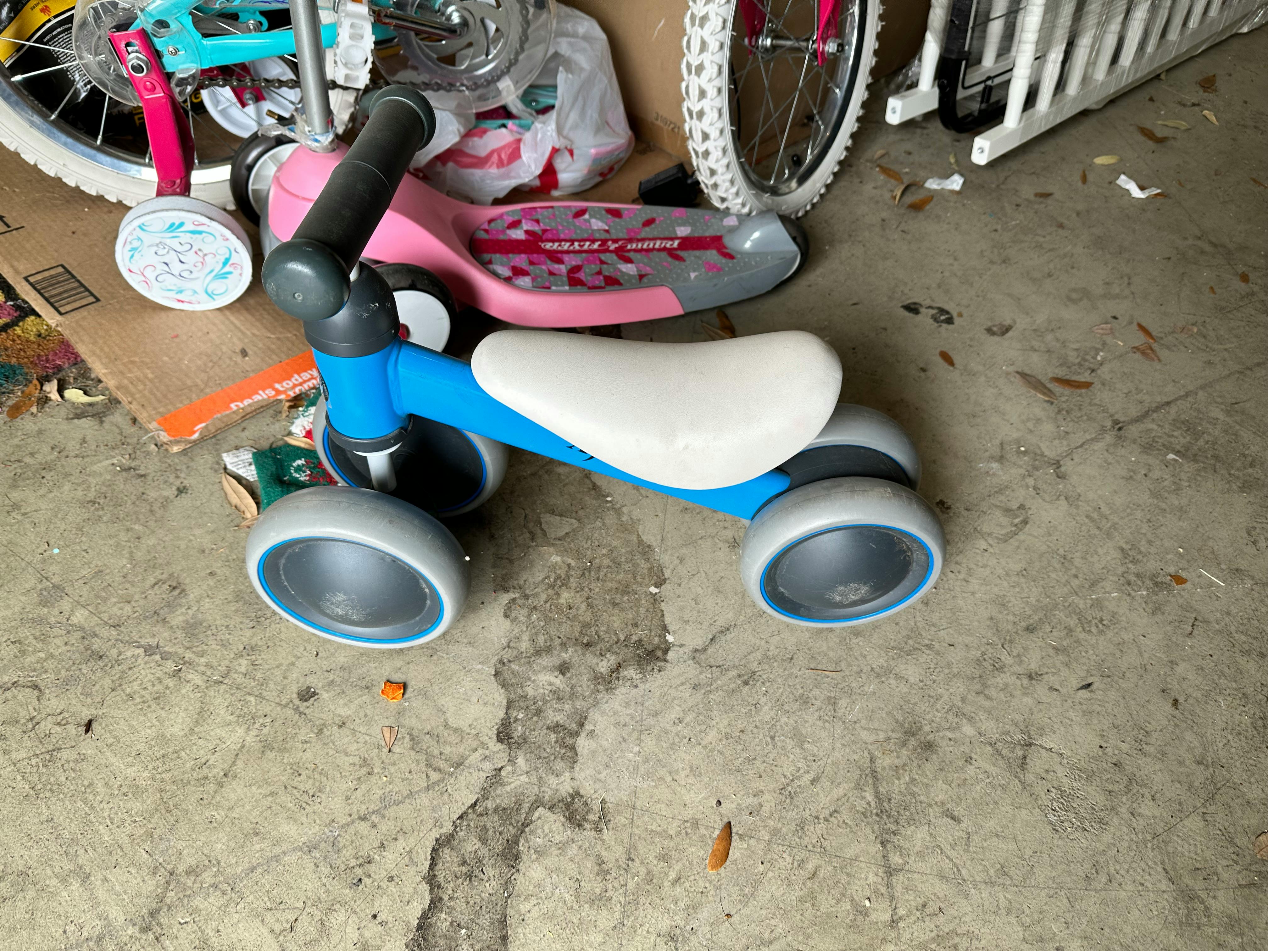 Blue and white balance bike on concrete