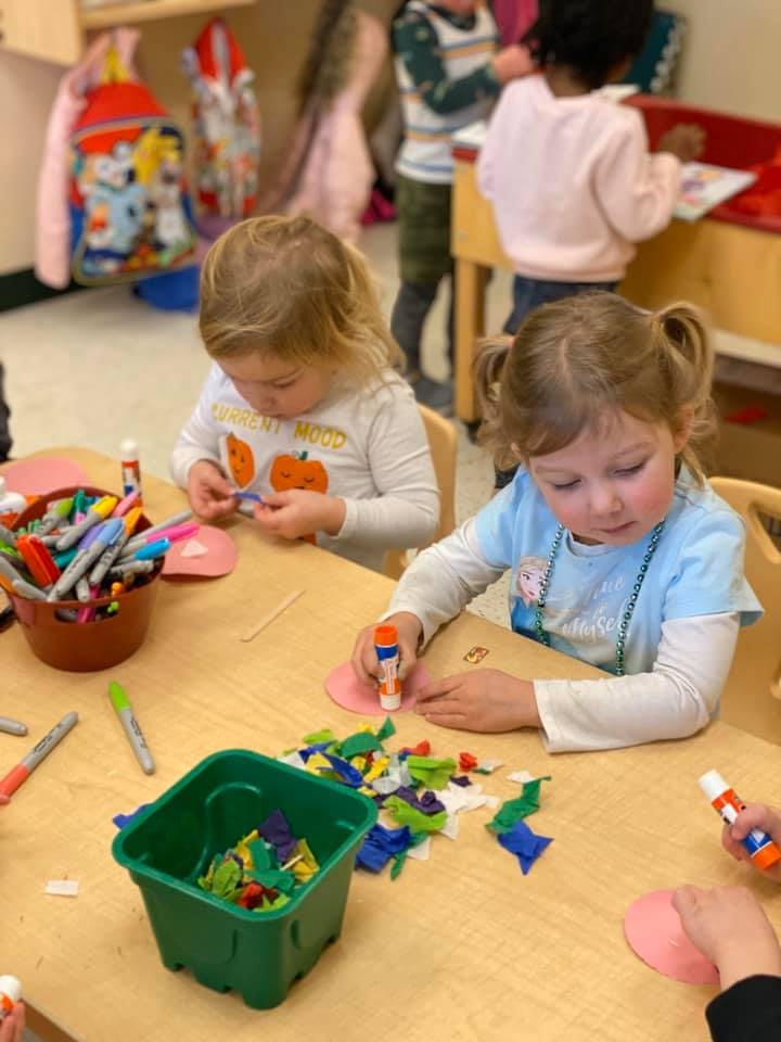 Two children doing crafts at a table