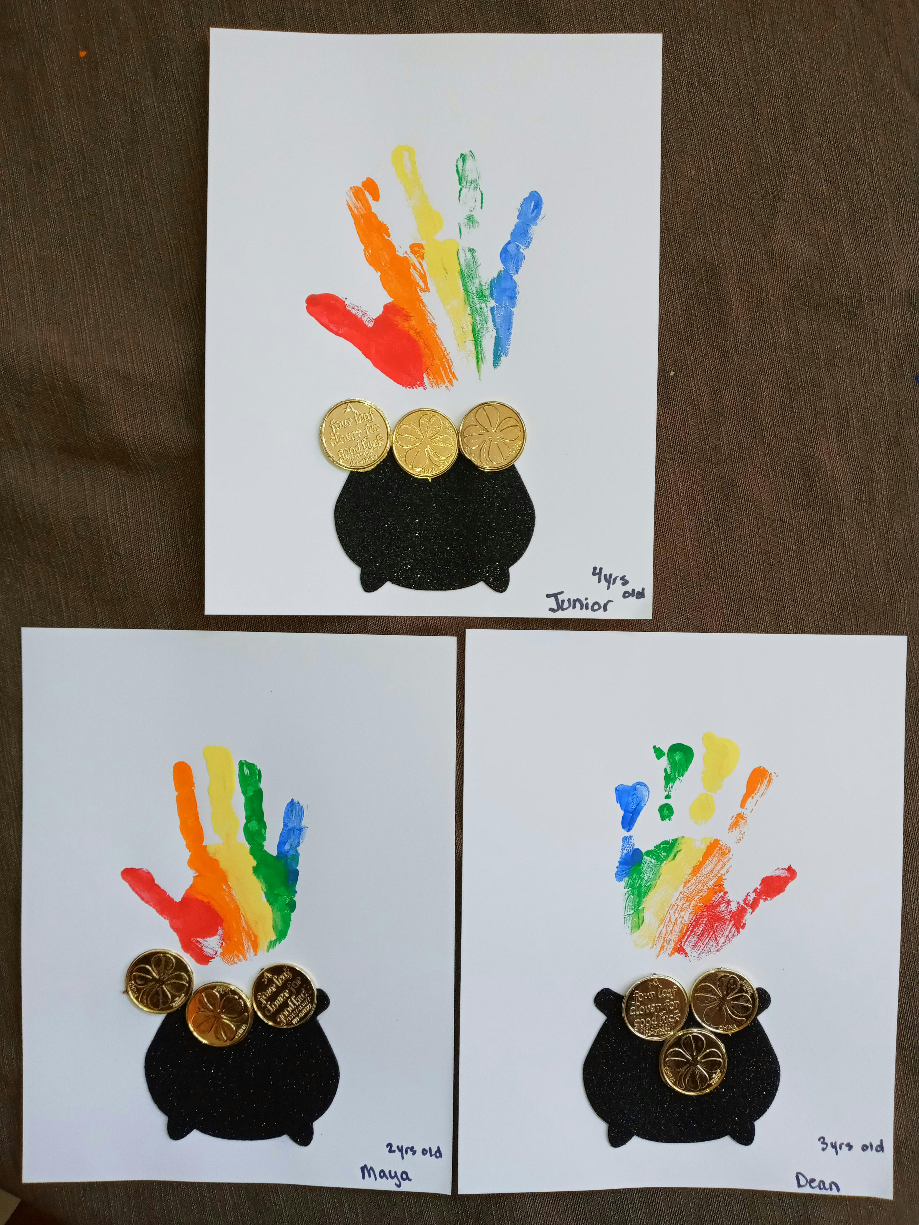 Three handprint rainbow art projects with pots of gold