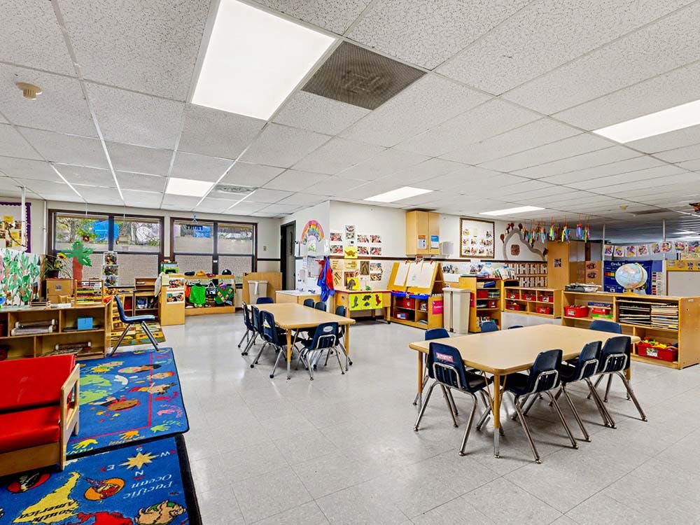A colorful empty classroom with tables and chairs