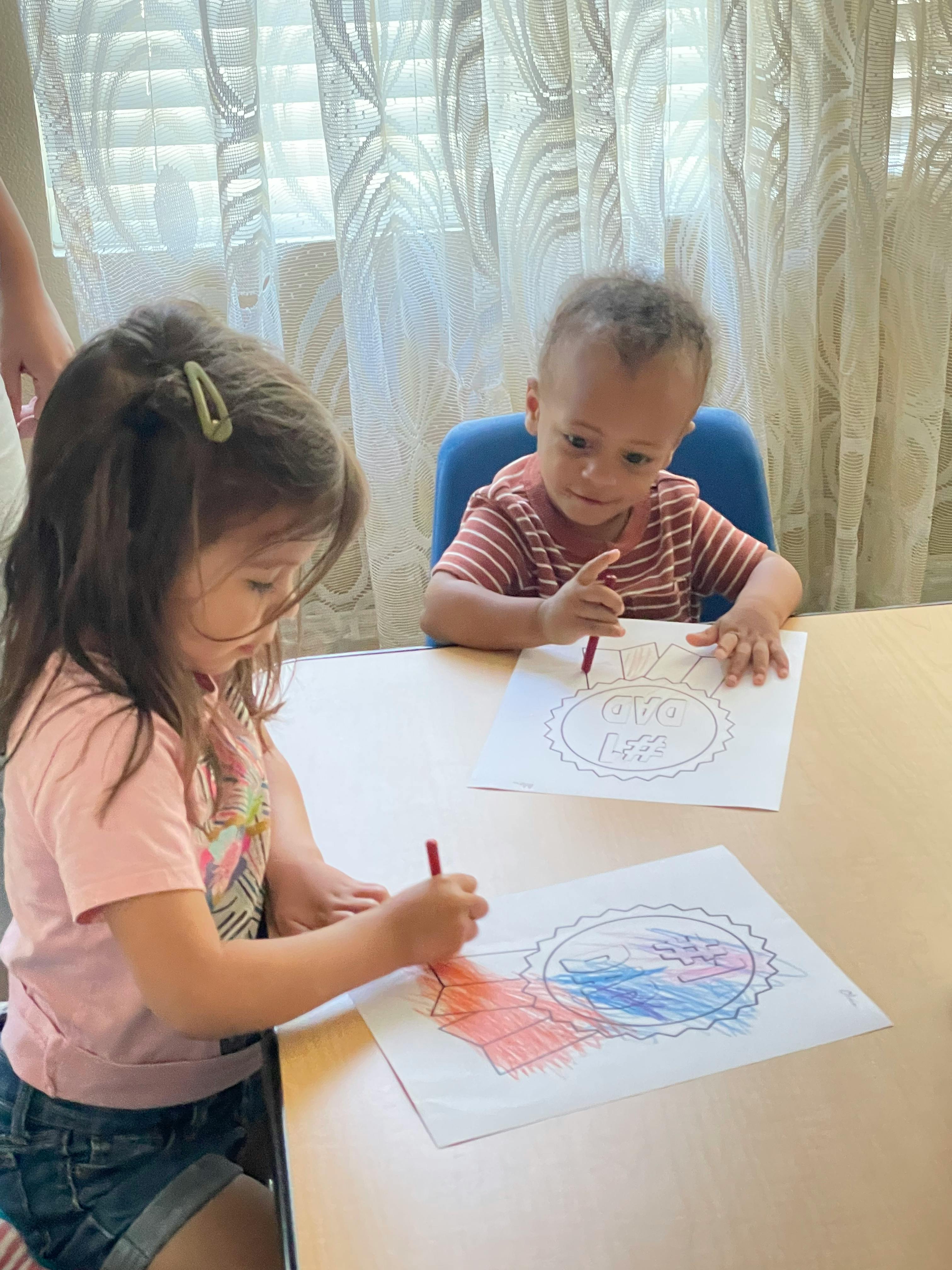 Two children coloring at a table