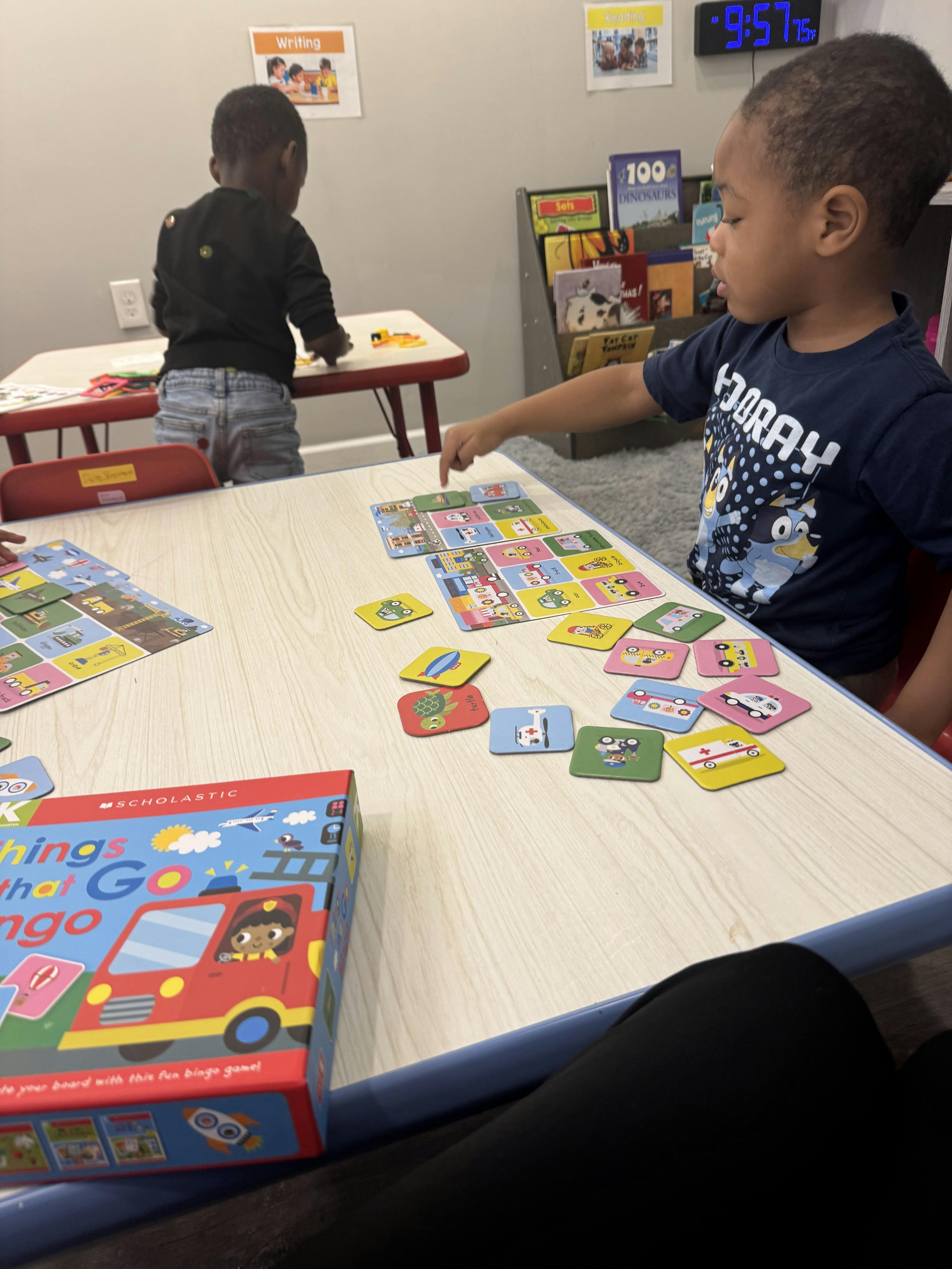 Child playing a board game at a table