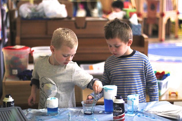 Two children doing a science experiment in a classroom