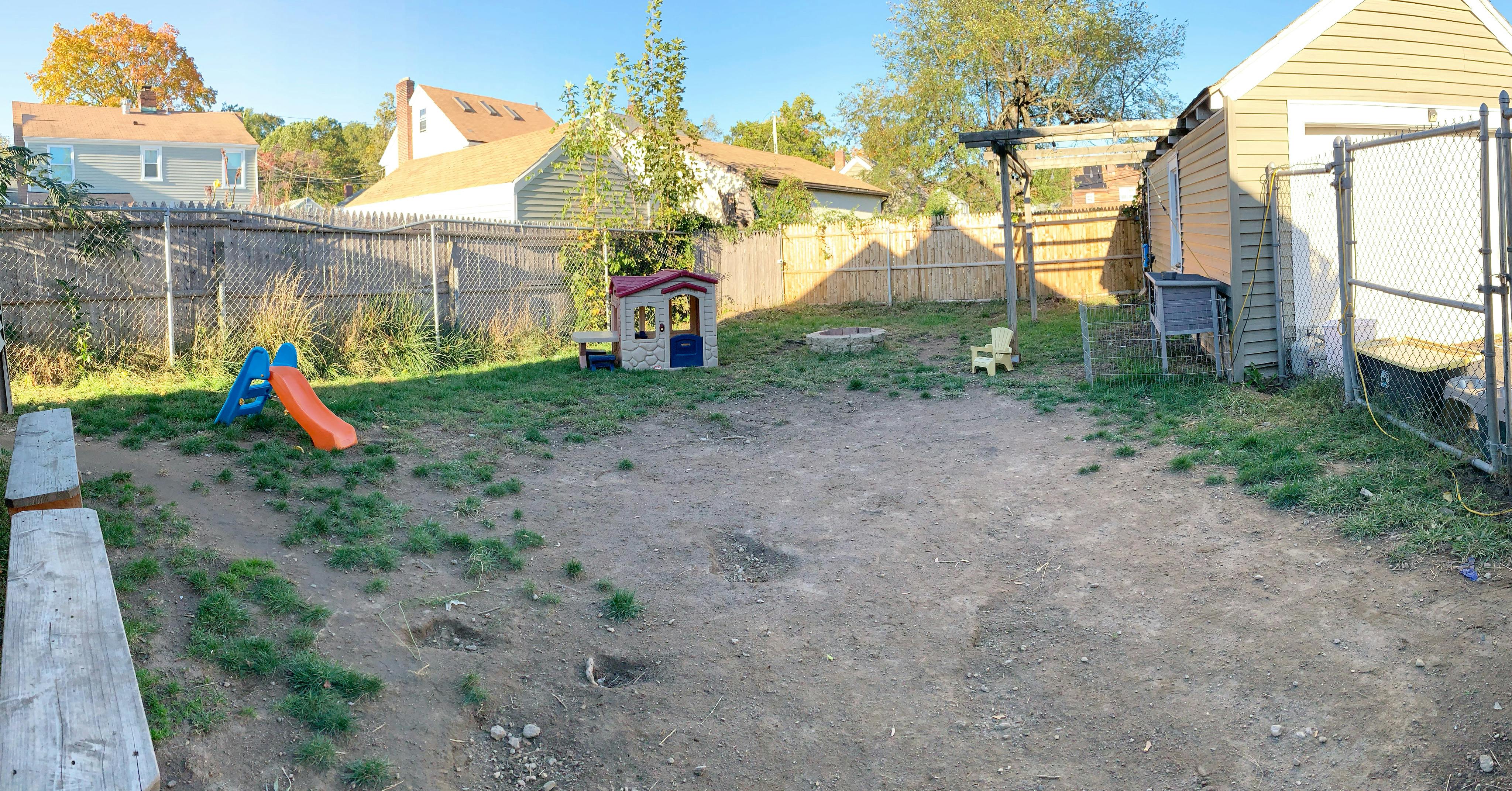 Backyard with a small slide and playhouse