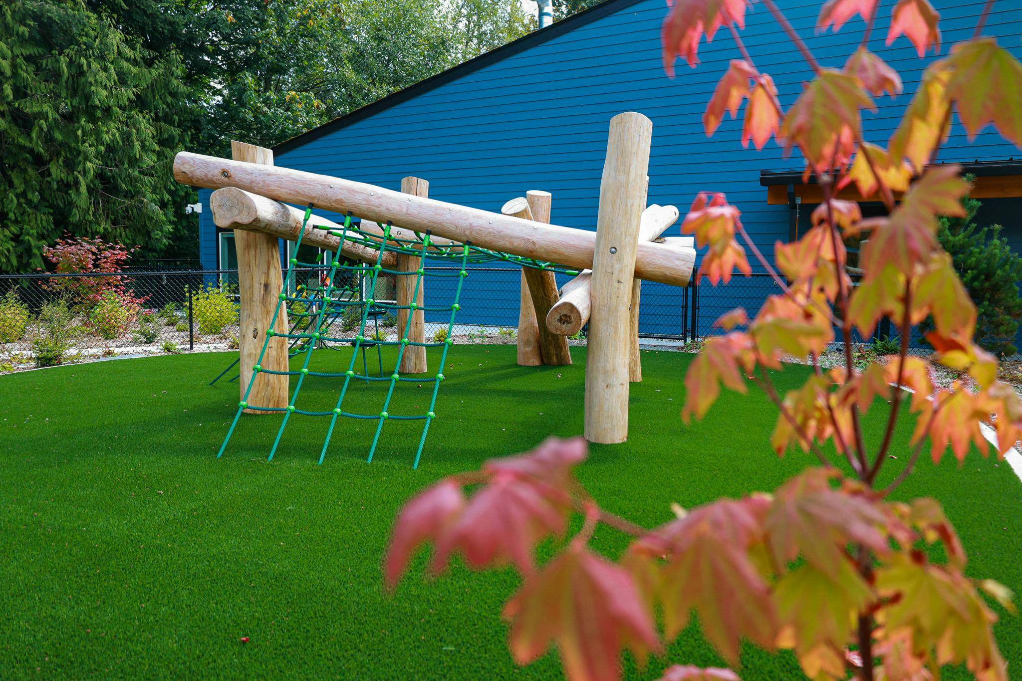 Wooden climbing structure with cargo net on a playground