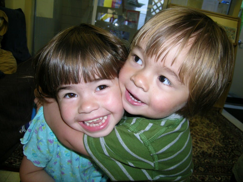 Two children hugging