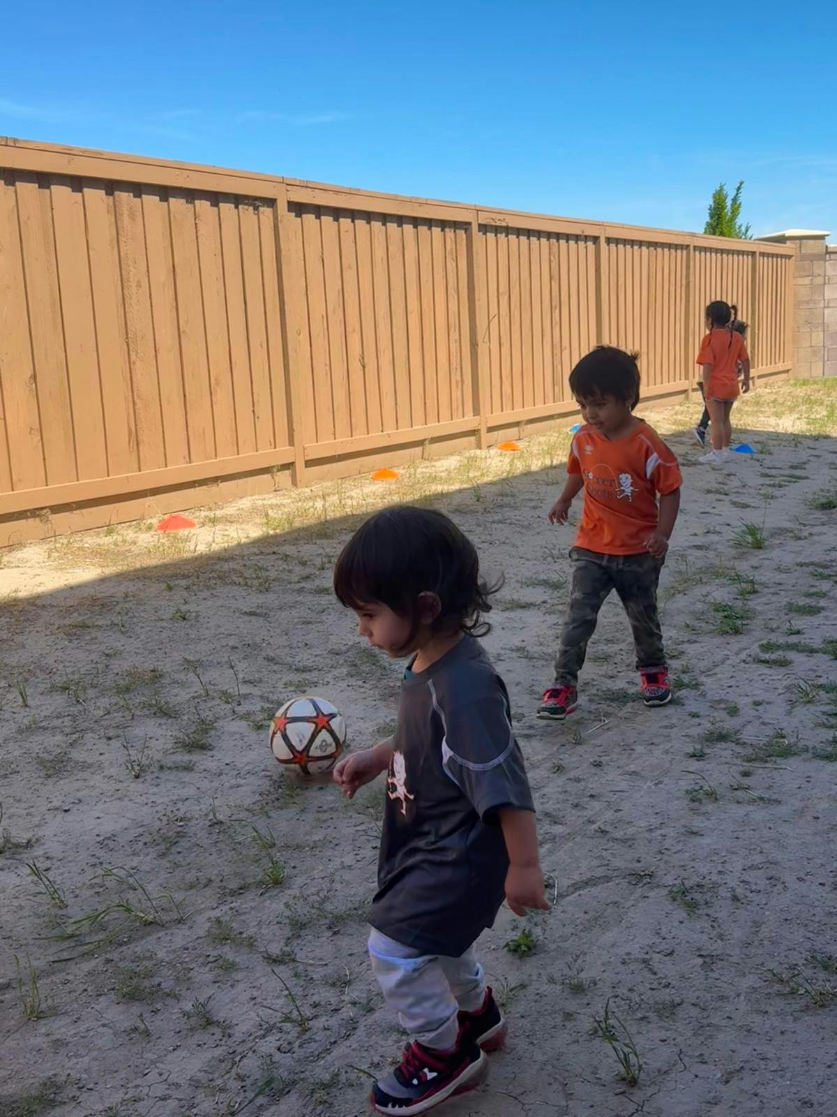 Children playing with a soccer ball outdoors