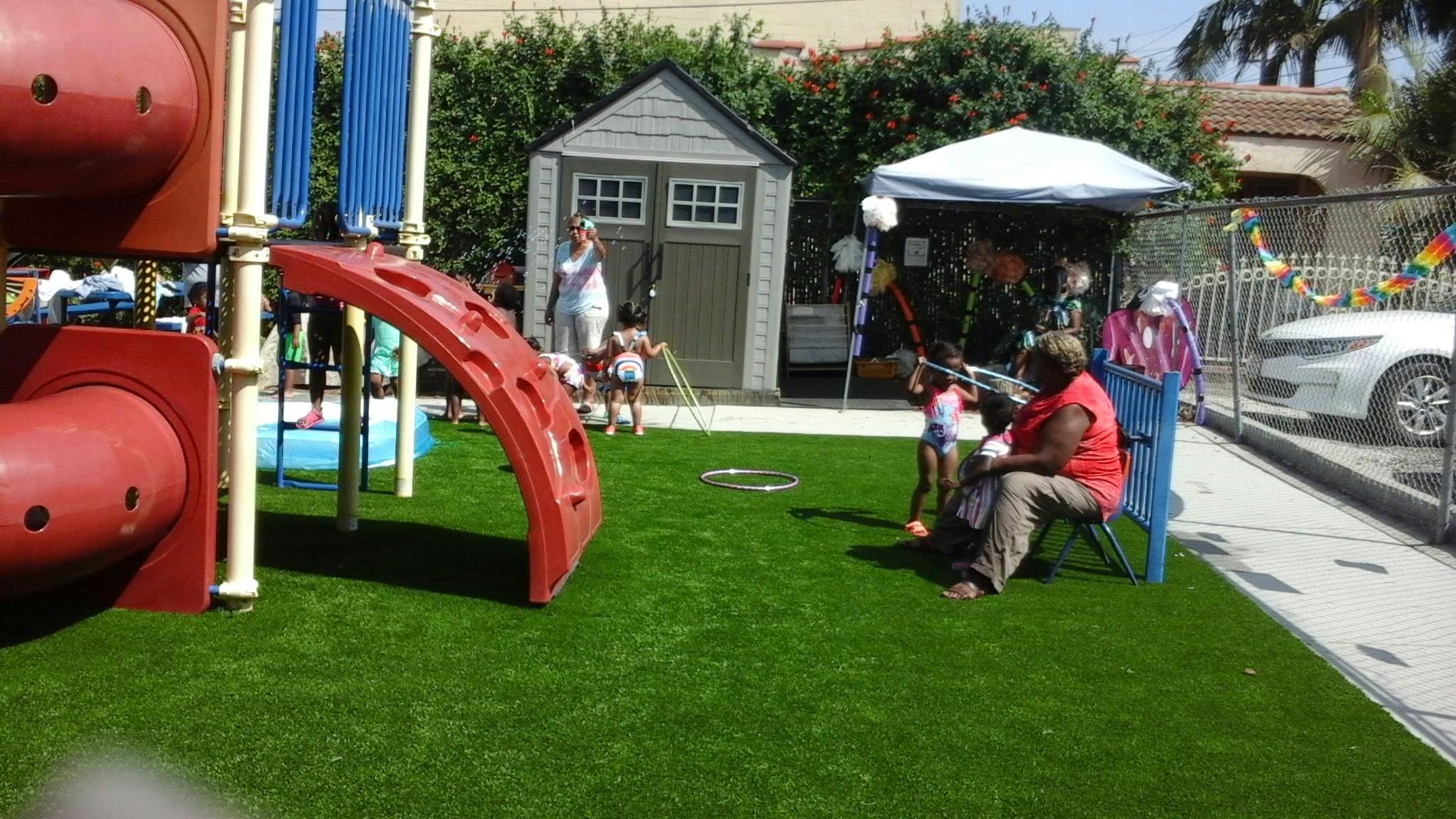People on a playground with artificial turf