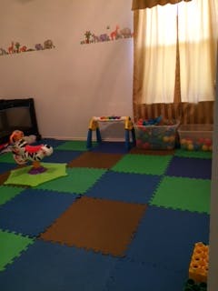 Playroom with colorful floor mats and toys