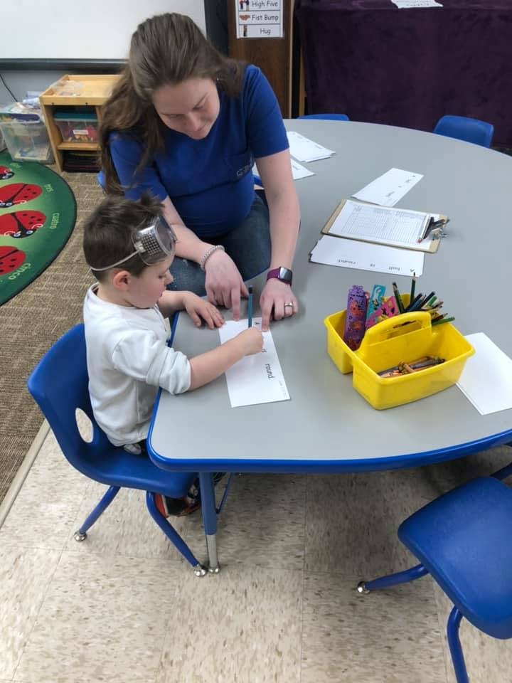 Adult and child writing at a table