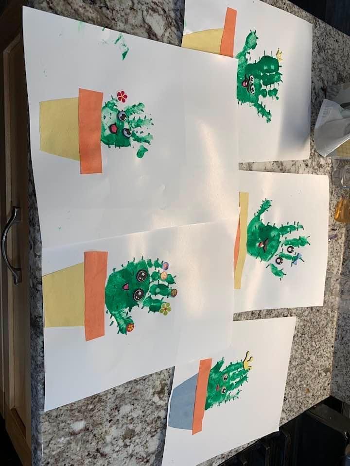 Multiple handprint cactus crafts with paper pots