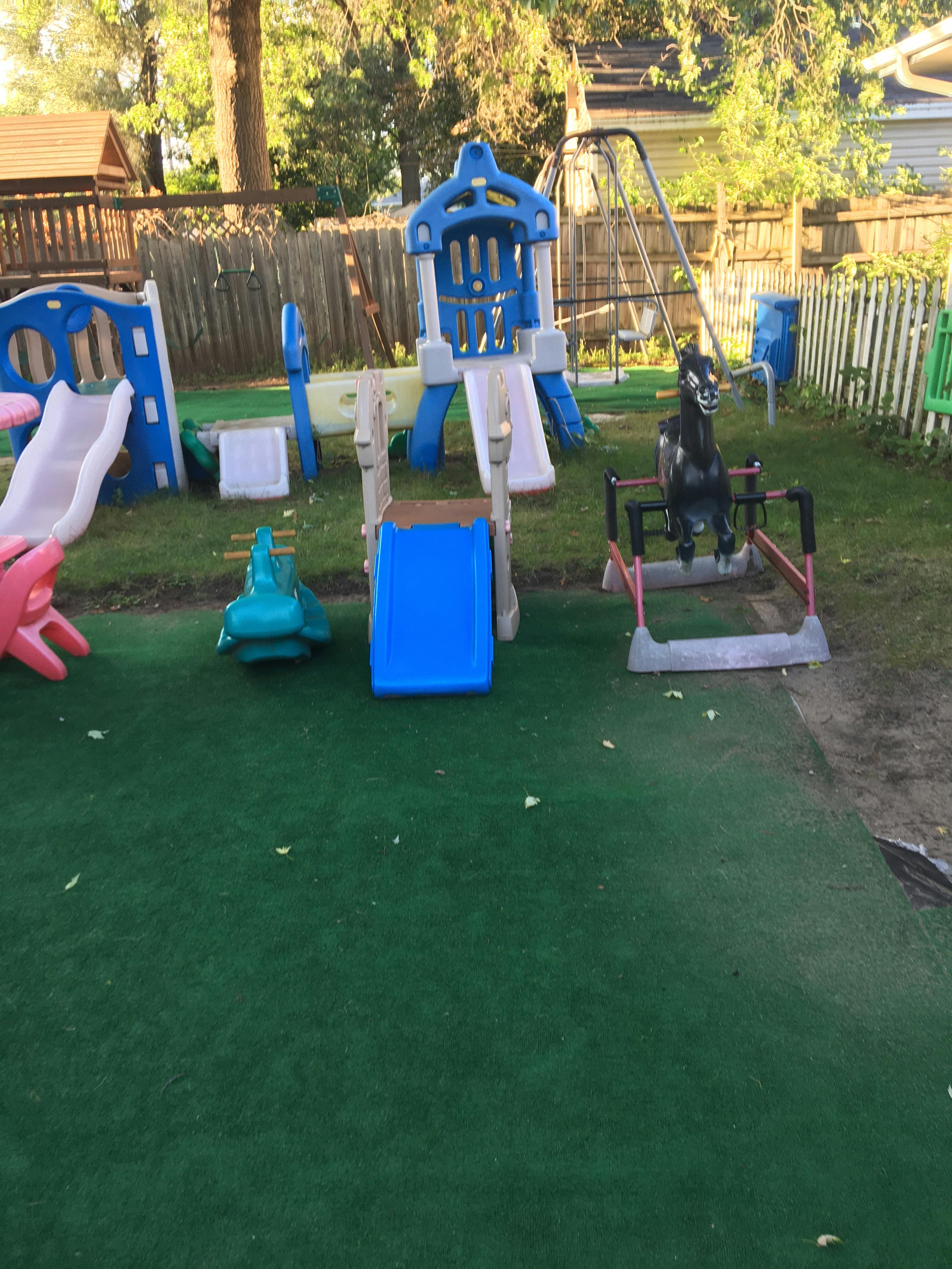 Outdoor playground with slides, swings, and spring riders