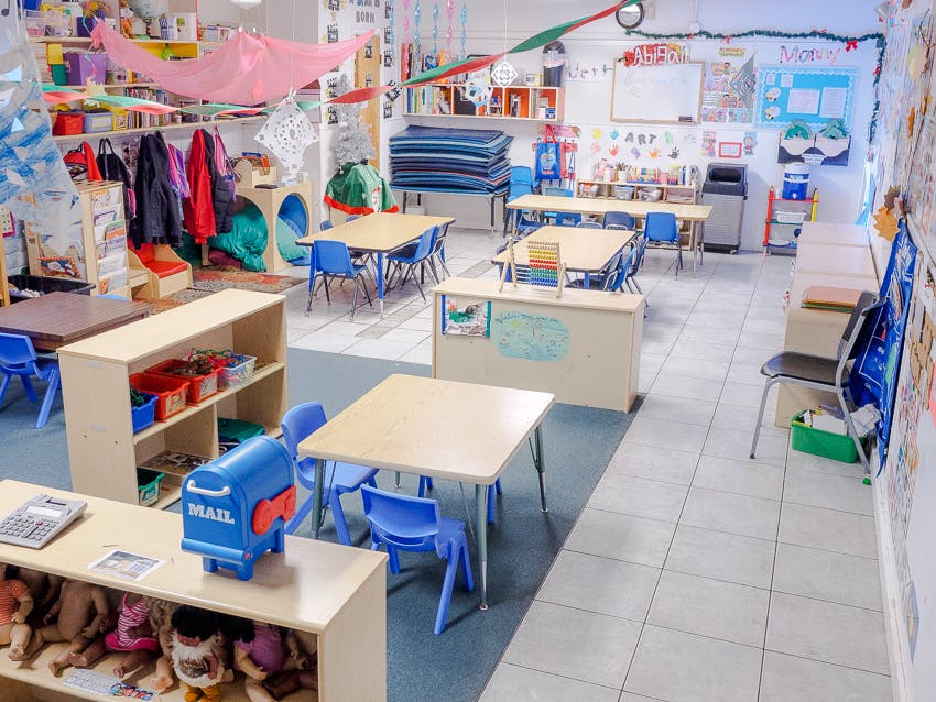 Empty classroom with small tables and chairs