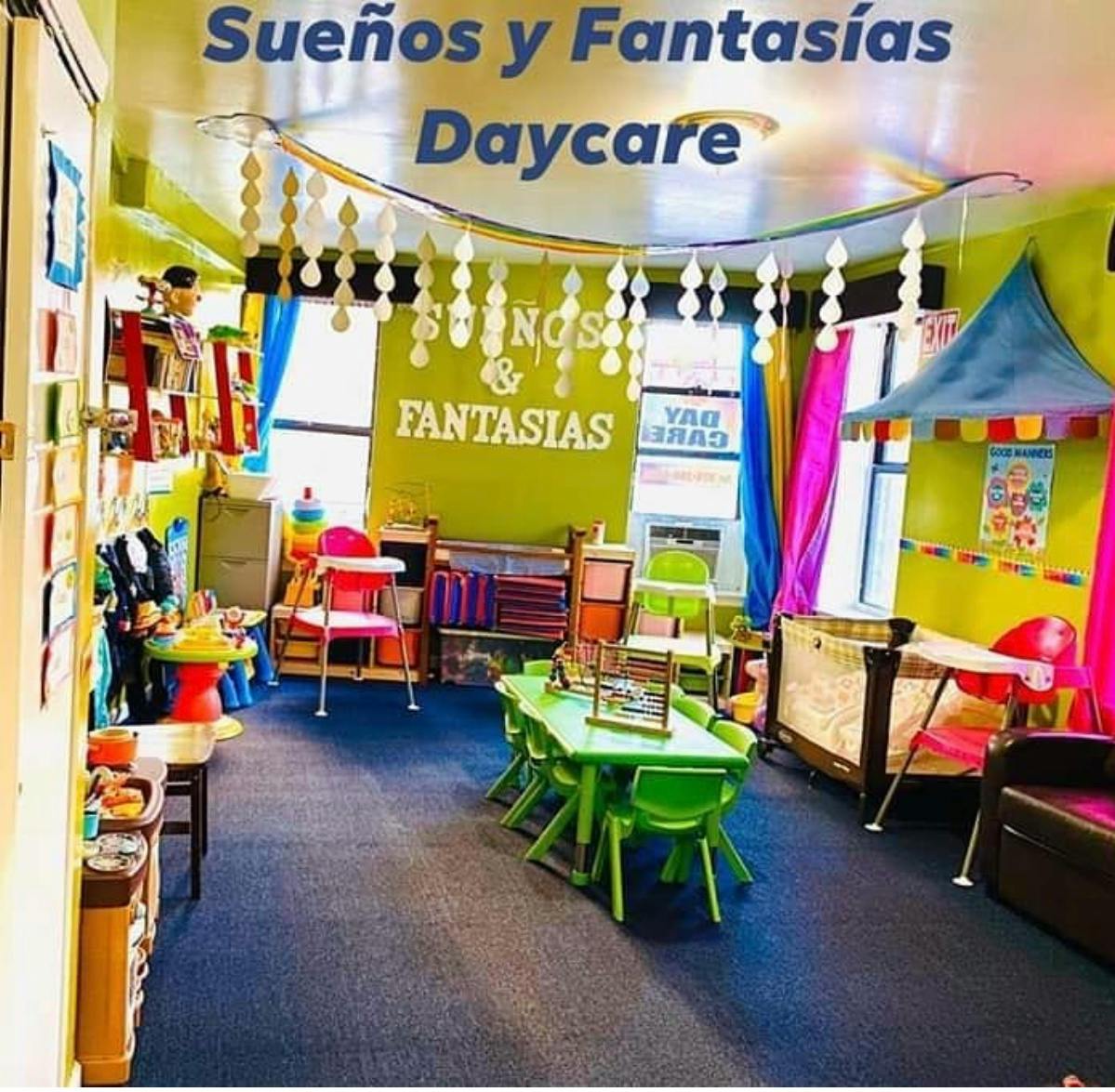 Daycare room with small green tables and chairs, crib, and play tent