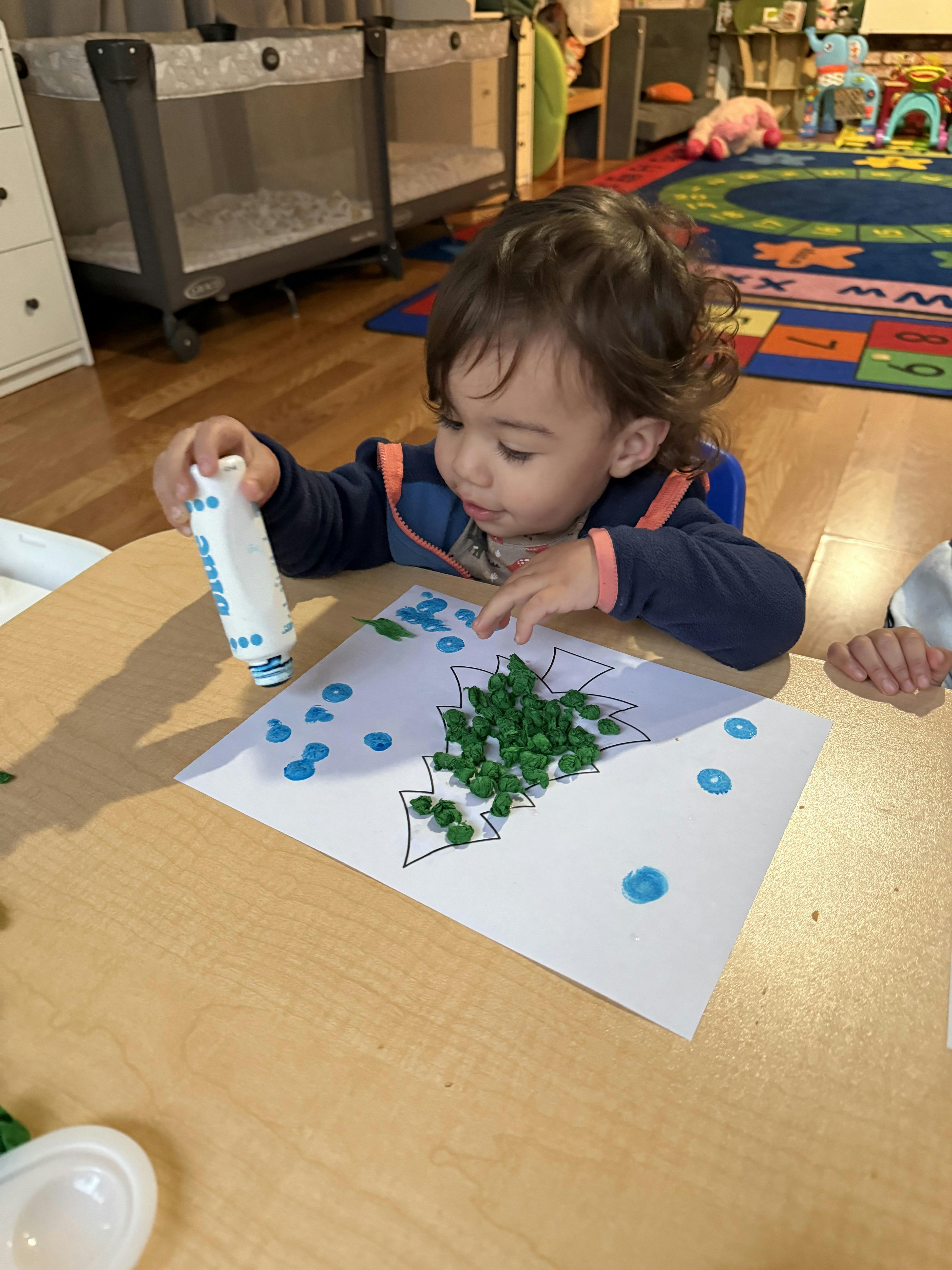 Child doing an art activity at a table