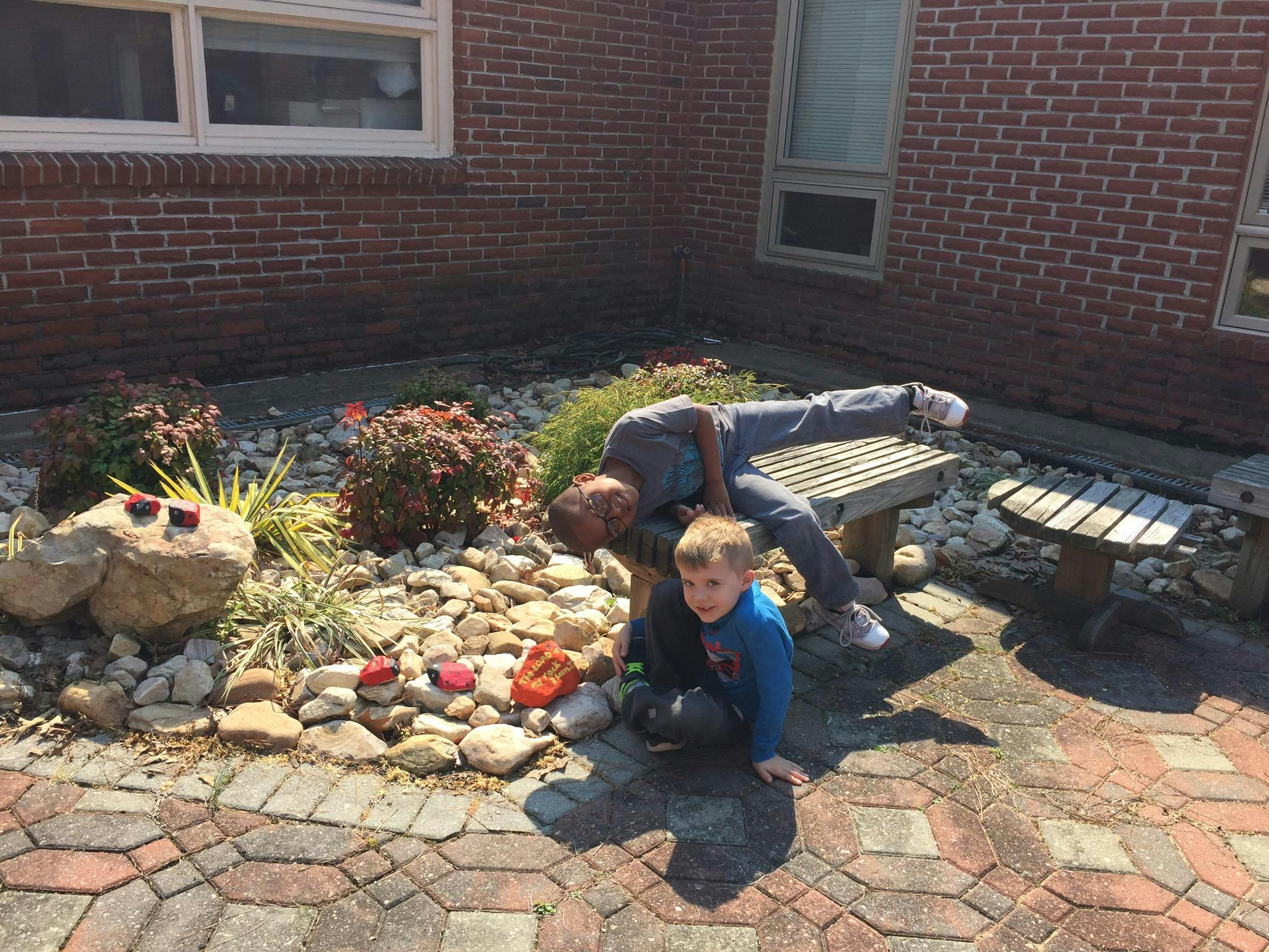 Person and child looking at rocks in a garden