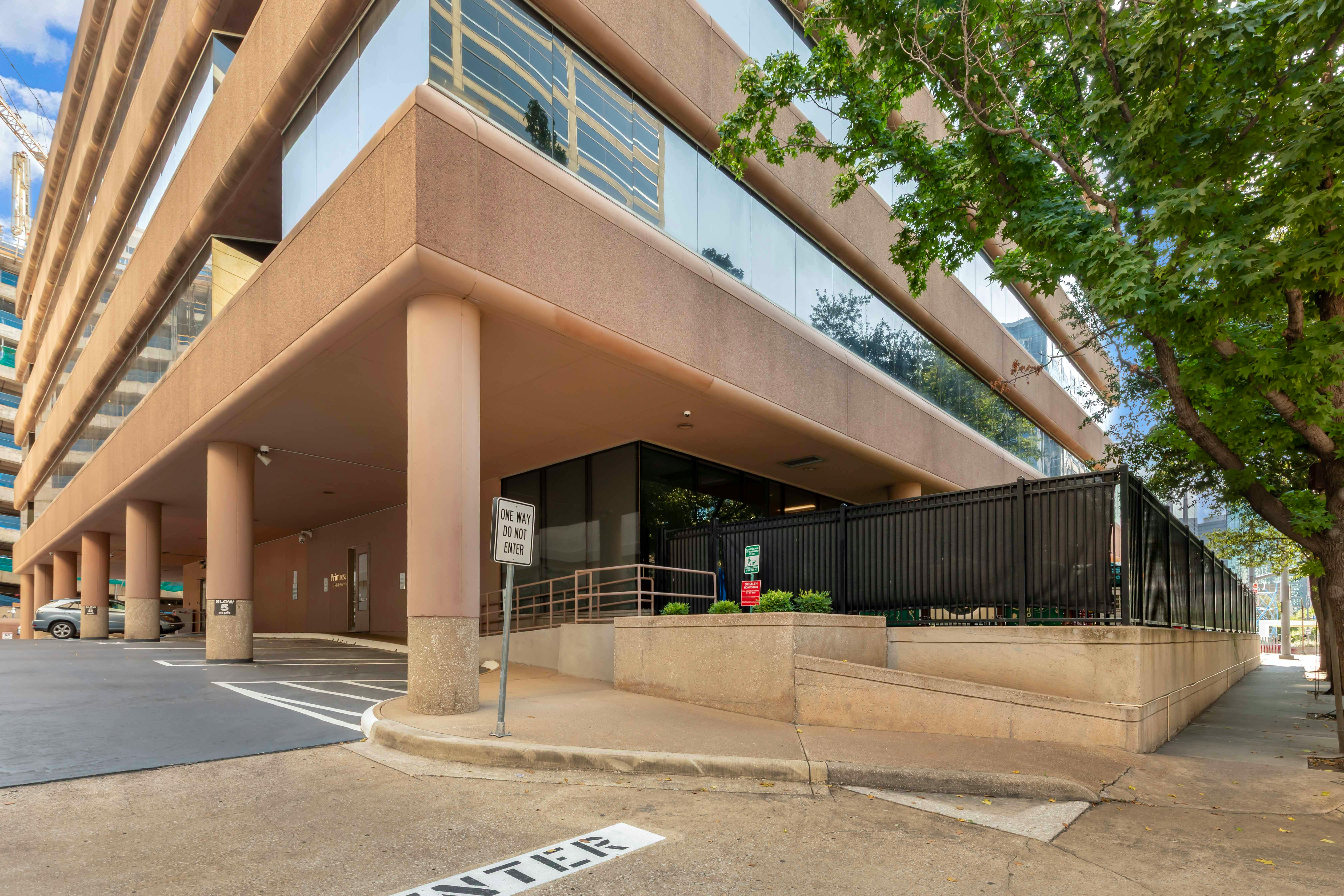 Entrance to an underground parking garage with a one-way sign