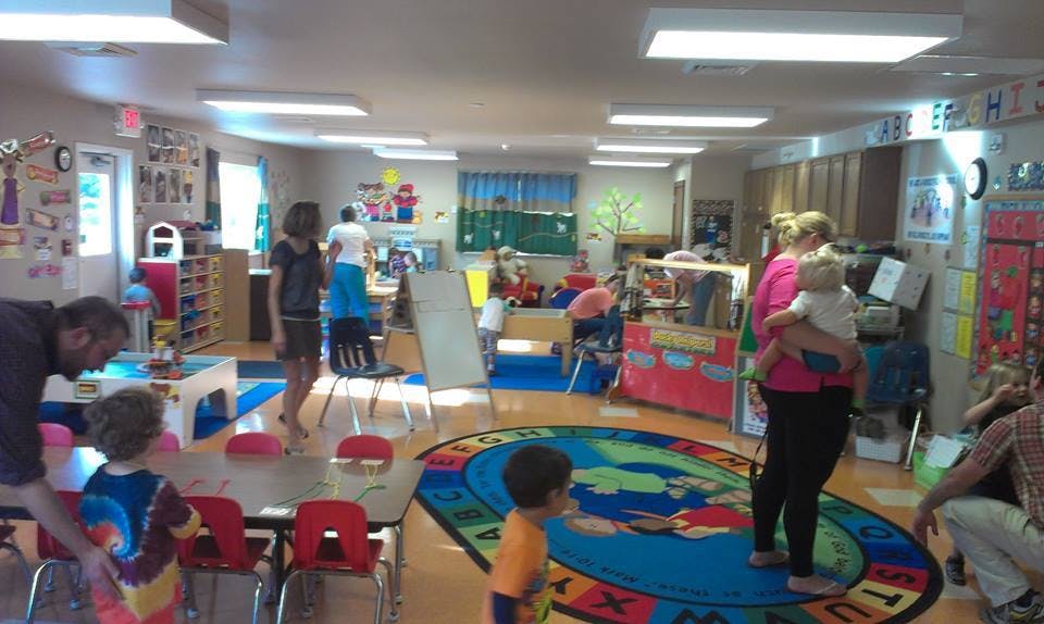 People and children in a classroom