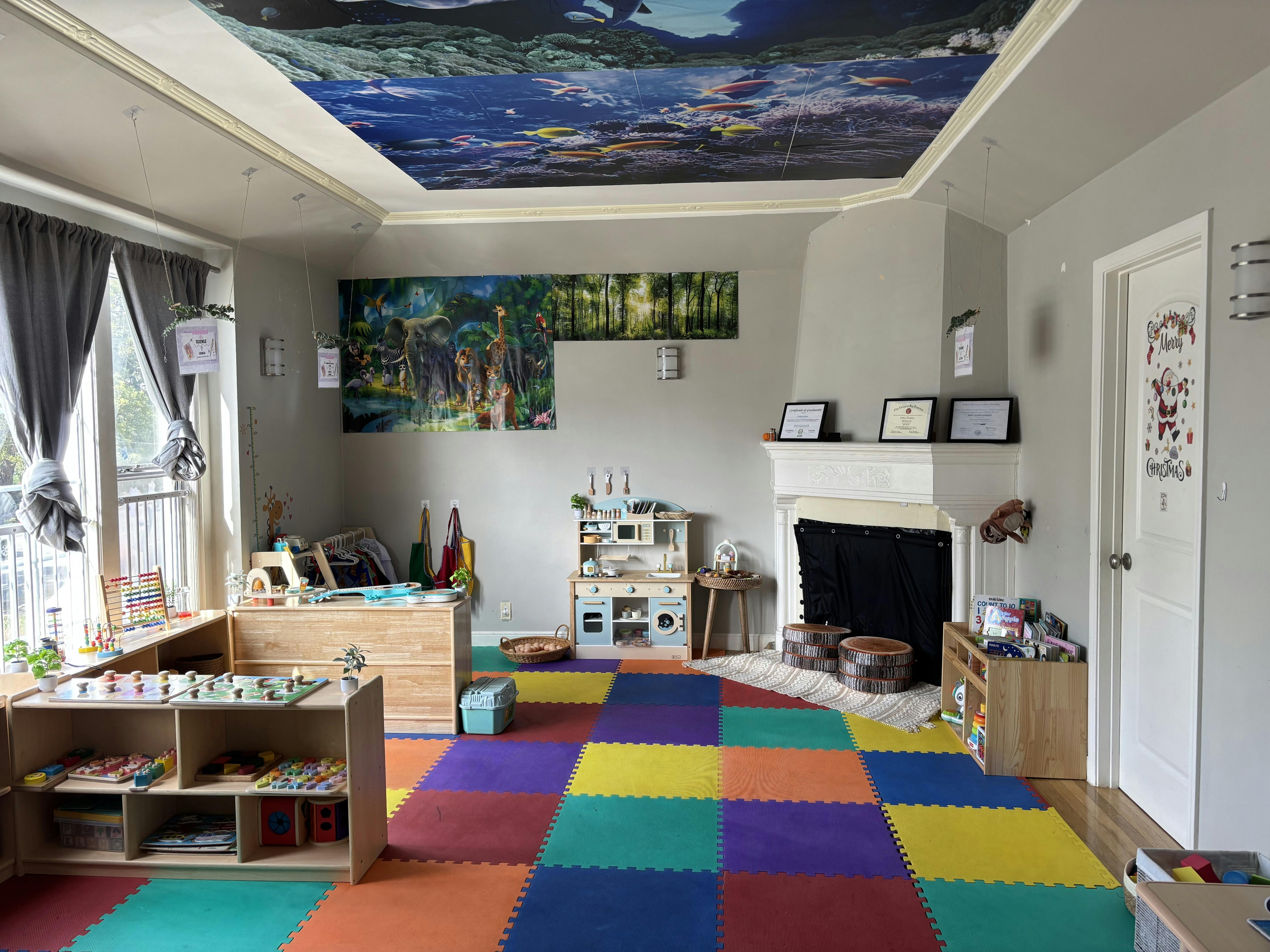 Playroom with colorful floor mats, toy kitchen, and shelves