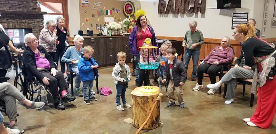 People and children gathered around a game