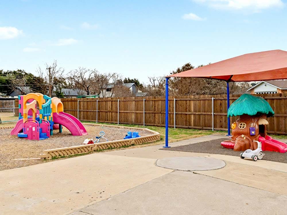 Colorful playground with slides and a treehouse-shaped play structure