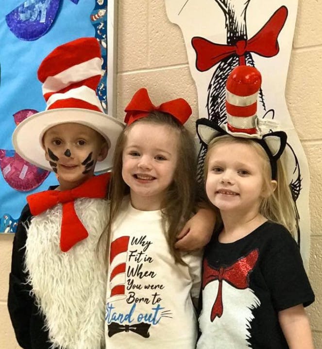 Three children in Cat in the Hat costumes