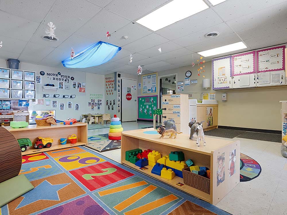Colorful classroom with play areas, toys, and educational decorations