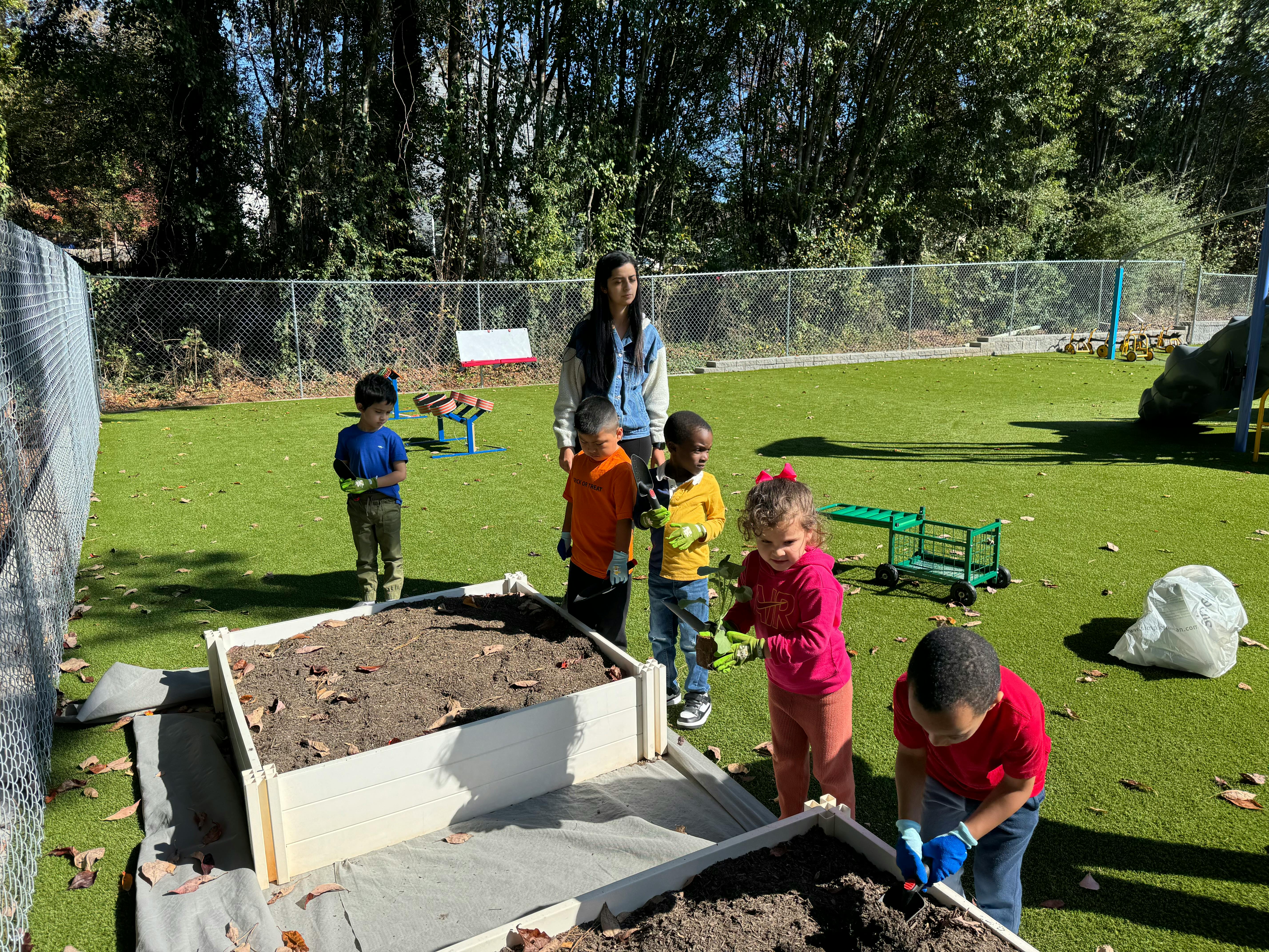 Adult and children gardening in raised beds