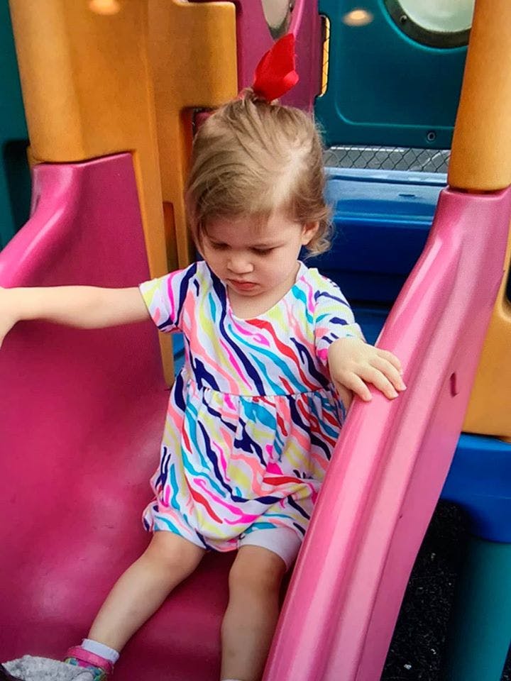 Child on a pink slide