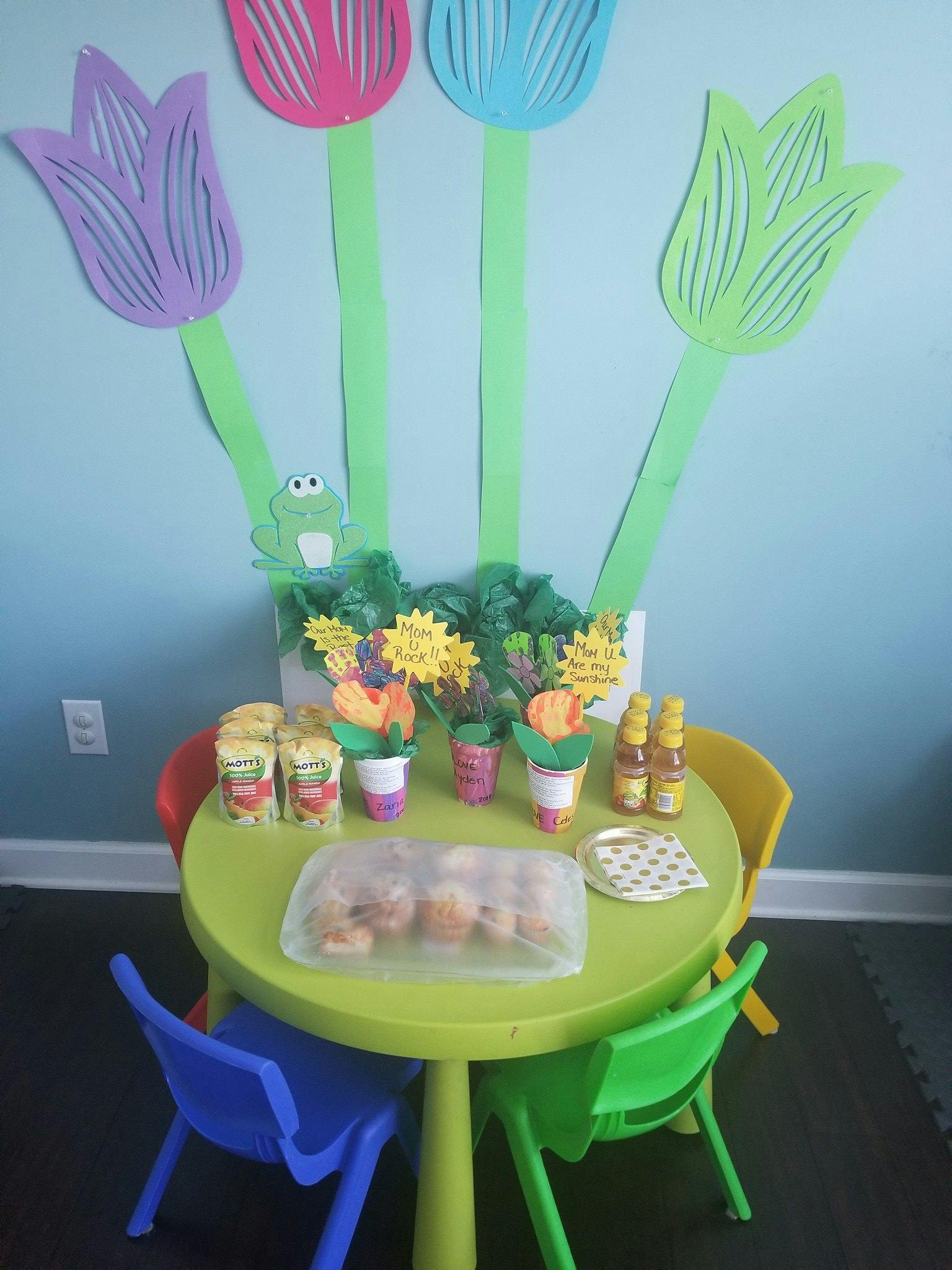 Small table with snacks and drinks, decorated with paper flowers