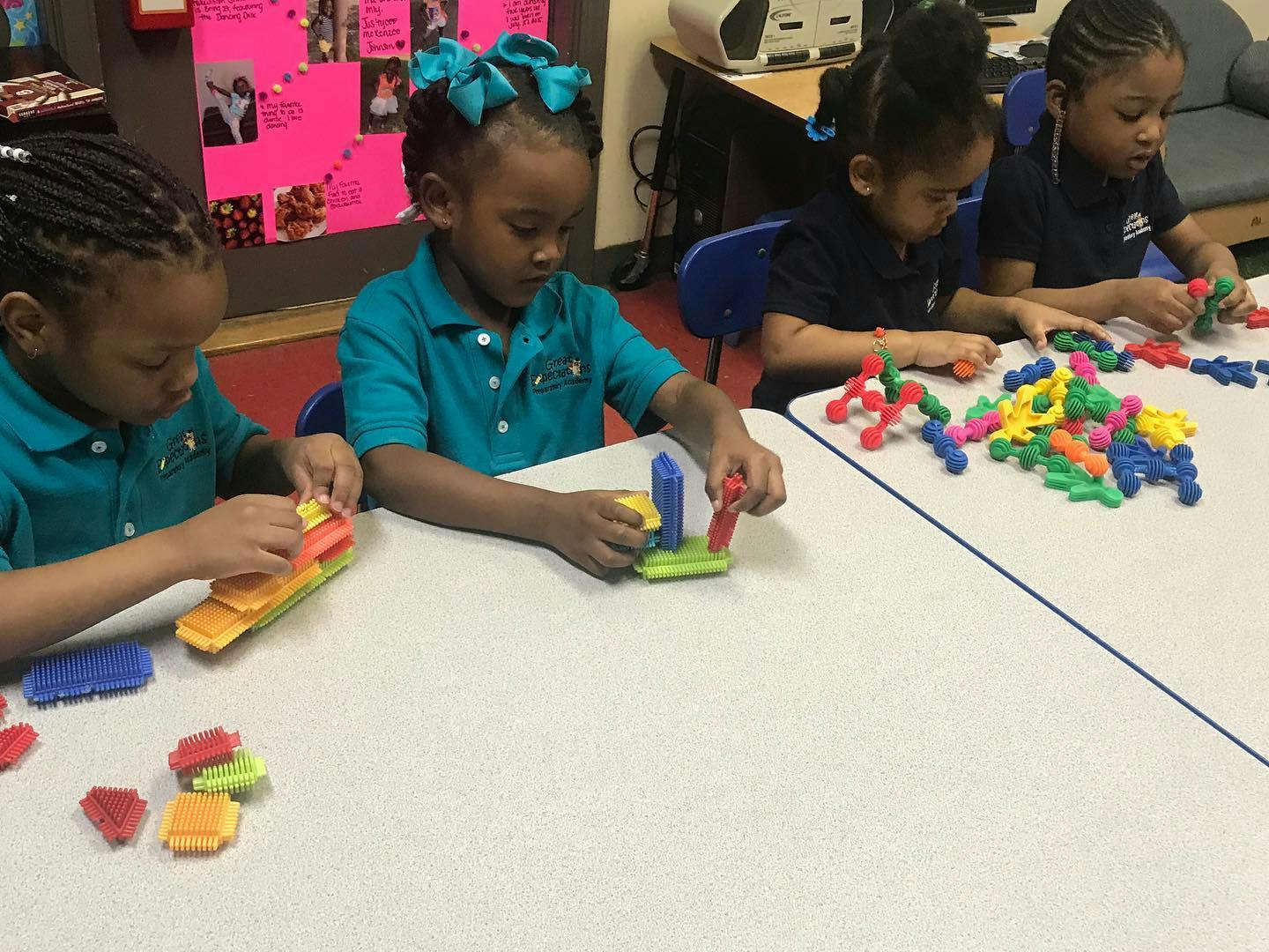Children playing with colorful building blocks at a table