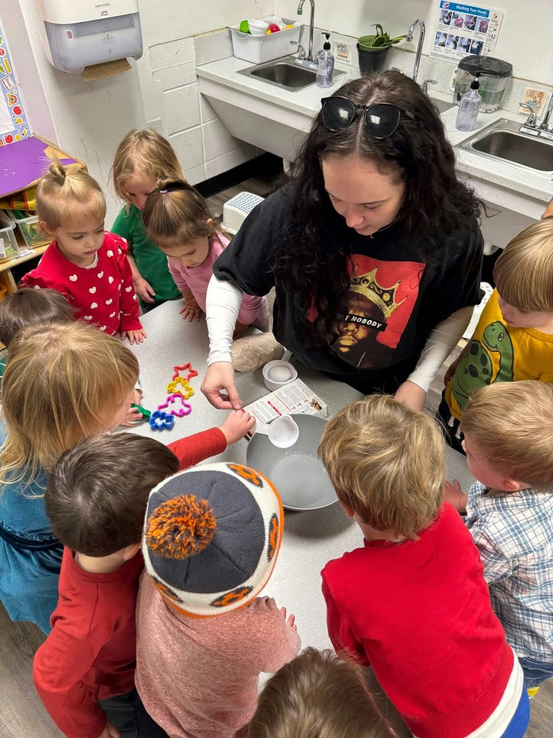 Person and children gathered around a table